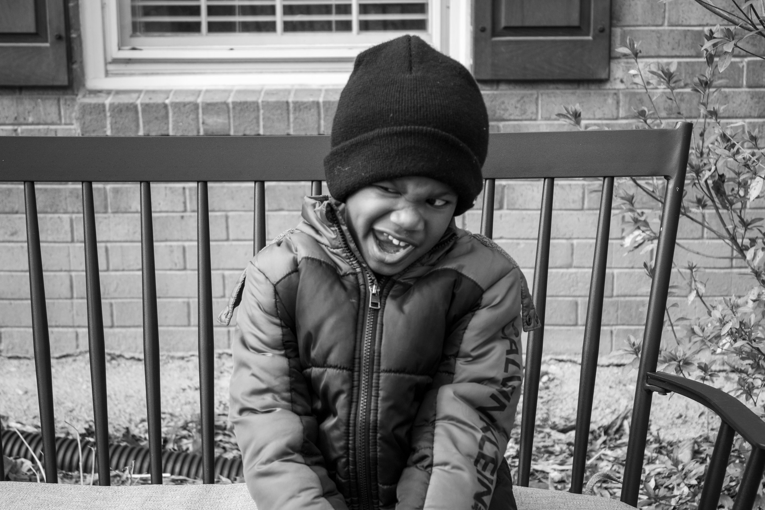 Portrait of a young boy making a silly face in black and white