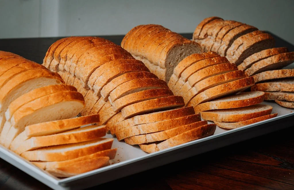 Sliced scratch-made loaf bread on a white tray