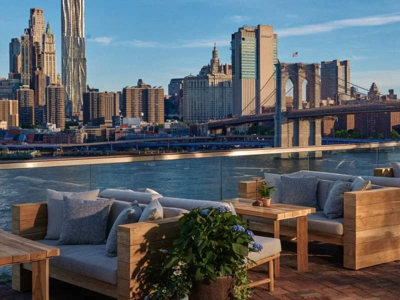 Daytime view of the Manhattan skyline and Brooklyn bridge from Harriets Rooftop lounge