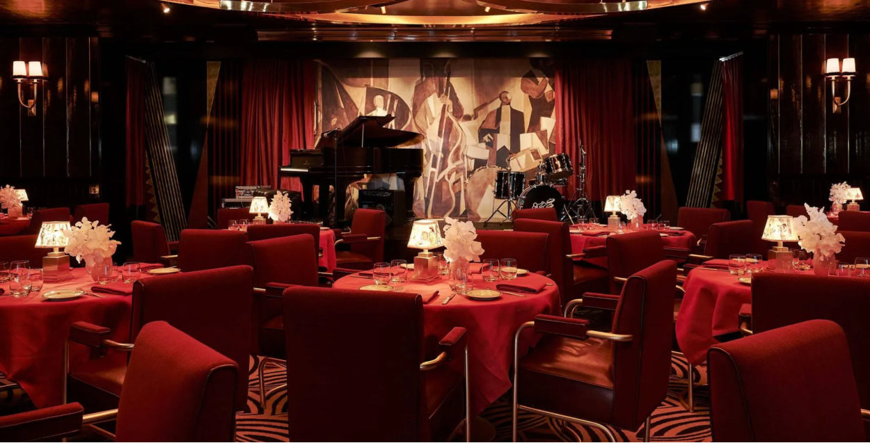 View inside the Jazz Club at Casa Cipriani showing red table seating and piano in the background