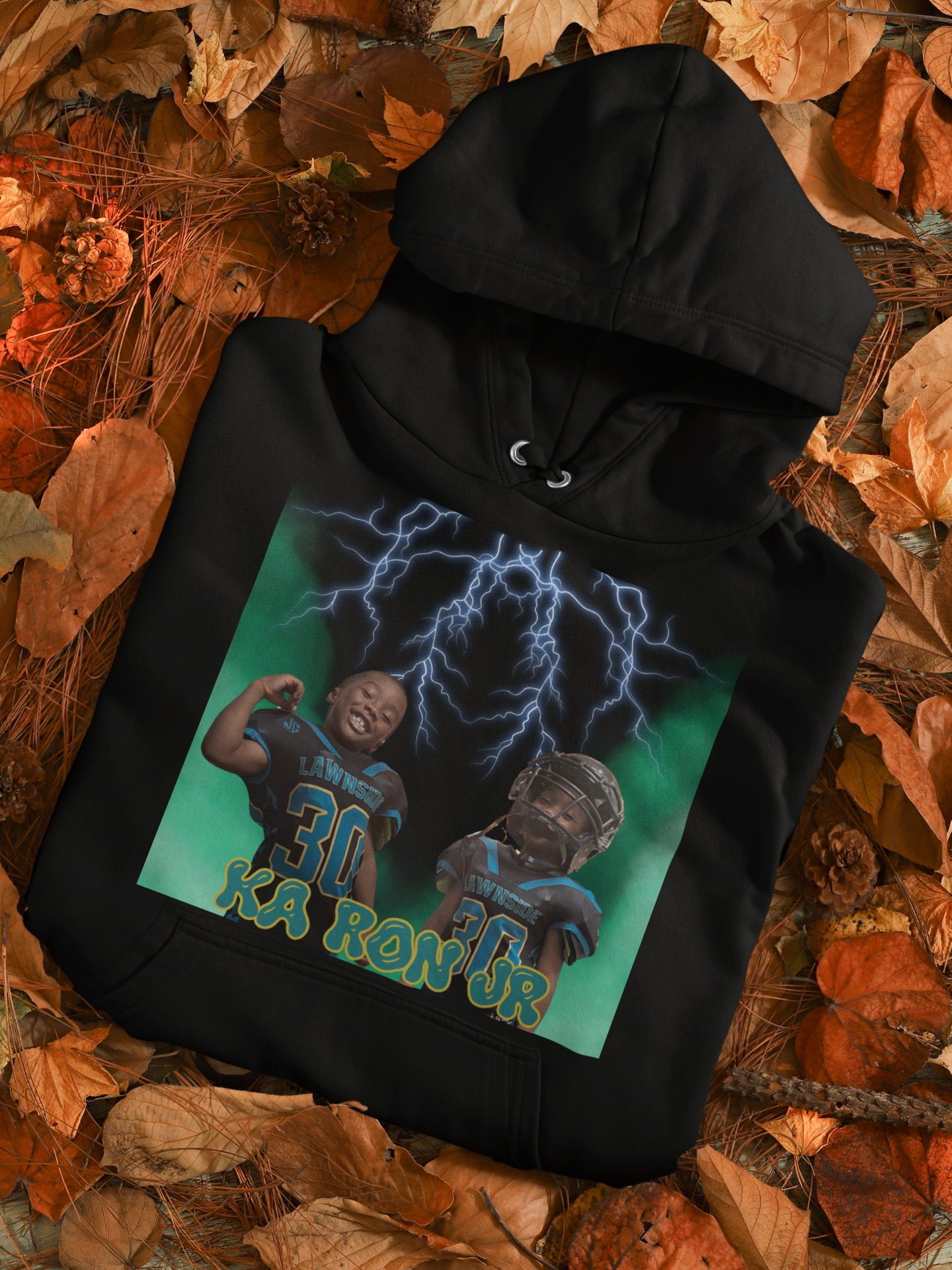 mockup-of-a-folded-pullover-hoodie-placed-over-autumn-leaves-m132-5.png