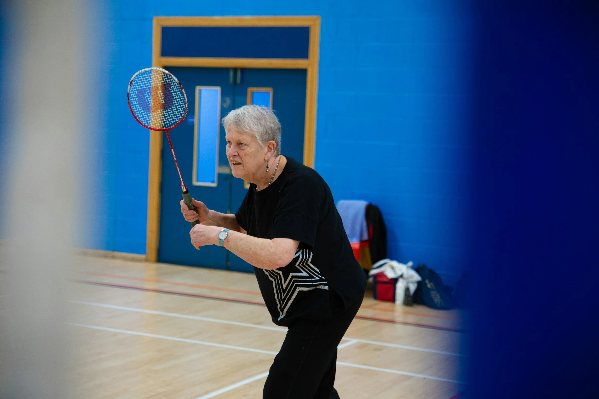 senior woman playing badminton