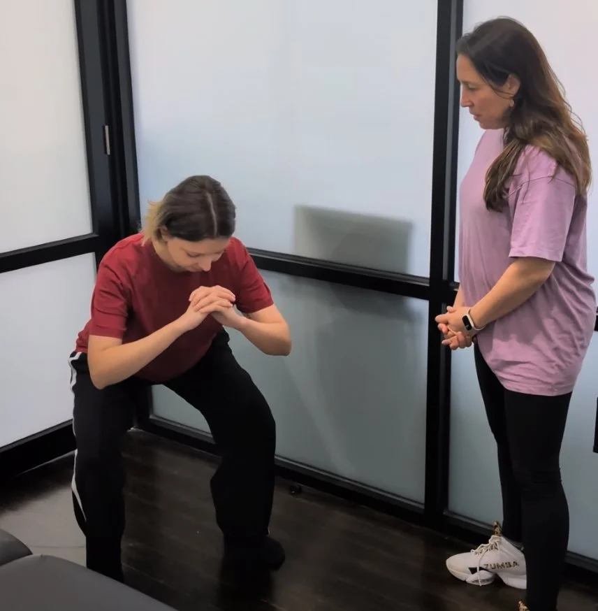 Stretch therapist assessing the squat of a patient at StretchWell in Melbourne