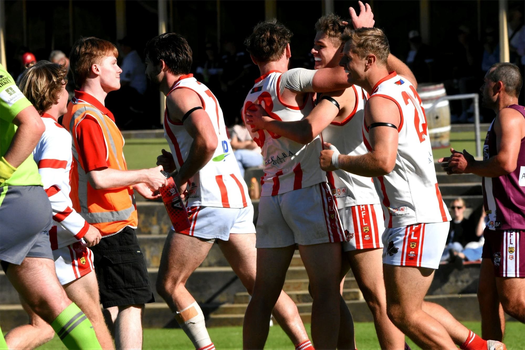 AFL players warming up on the pitch