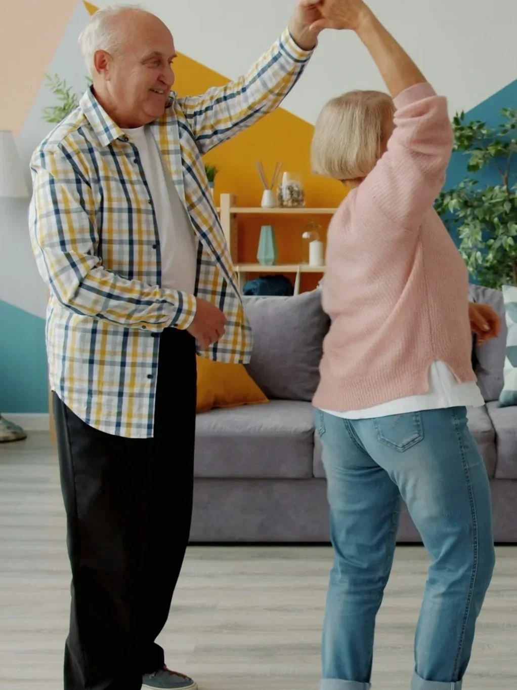 older couple dancing together in the living room