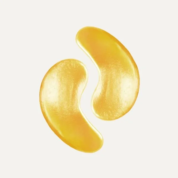 Two golden-colored kidney-shaped capsules against a white background.