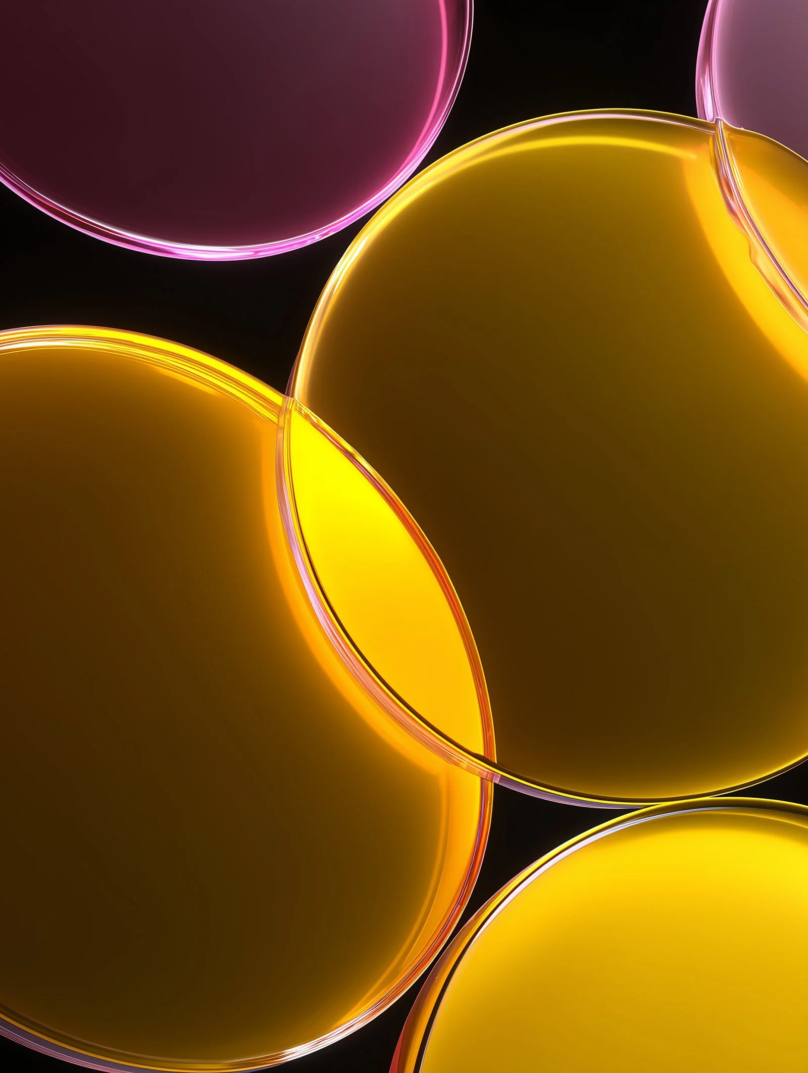 Abstract close-up of glowing, overlapping circular shapes in yellow, pink, and purple hues against a black background.