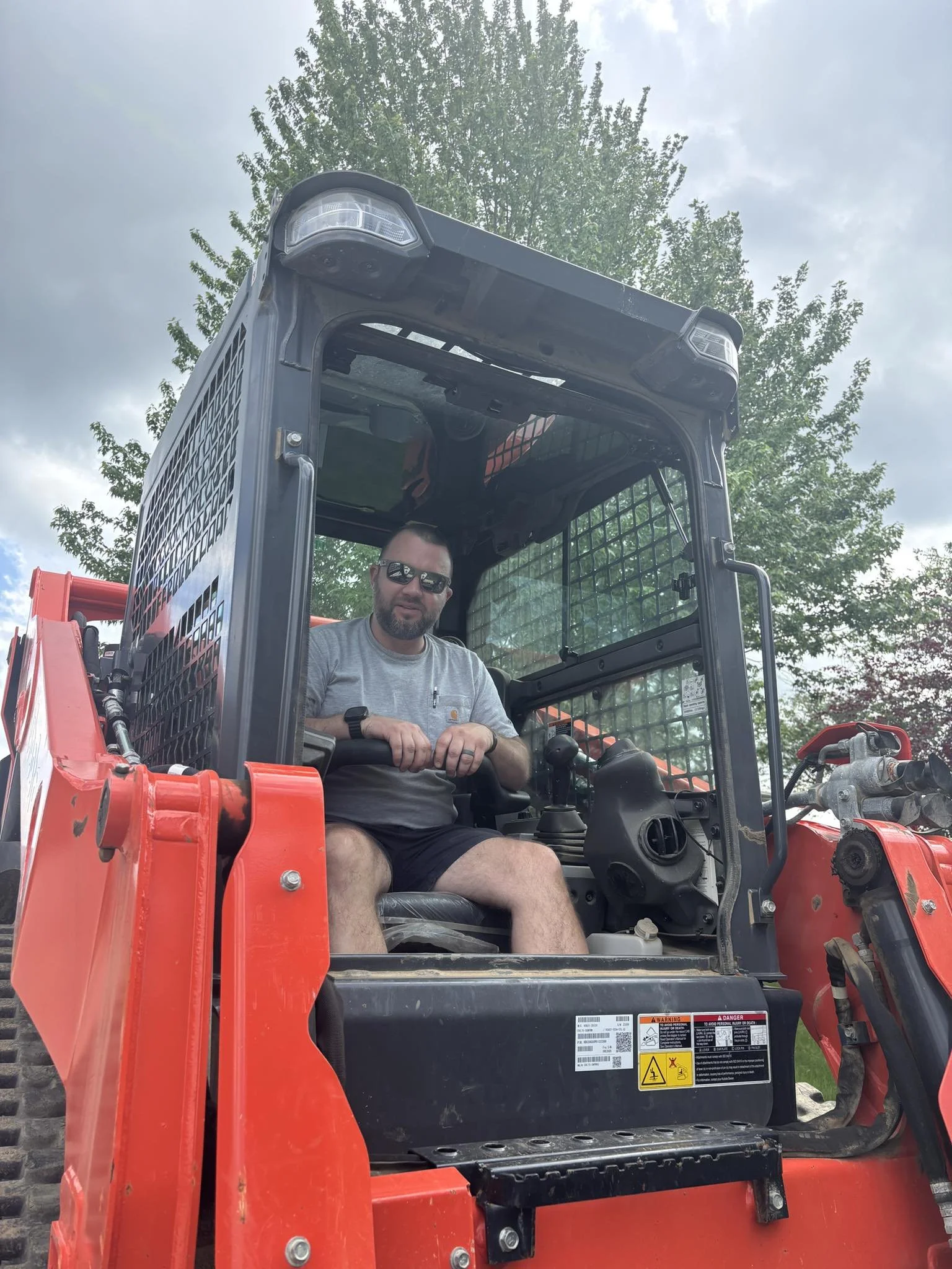 Doug Goens, owner of Kentucky Legacy Construction, seated in a skid steer while working on a Central Kentucky construction and excavation project.