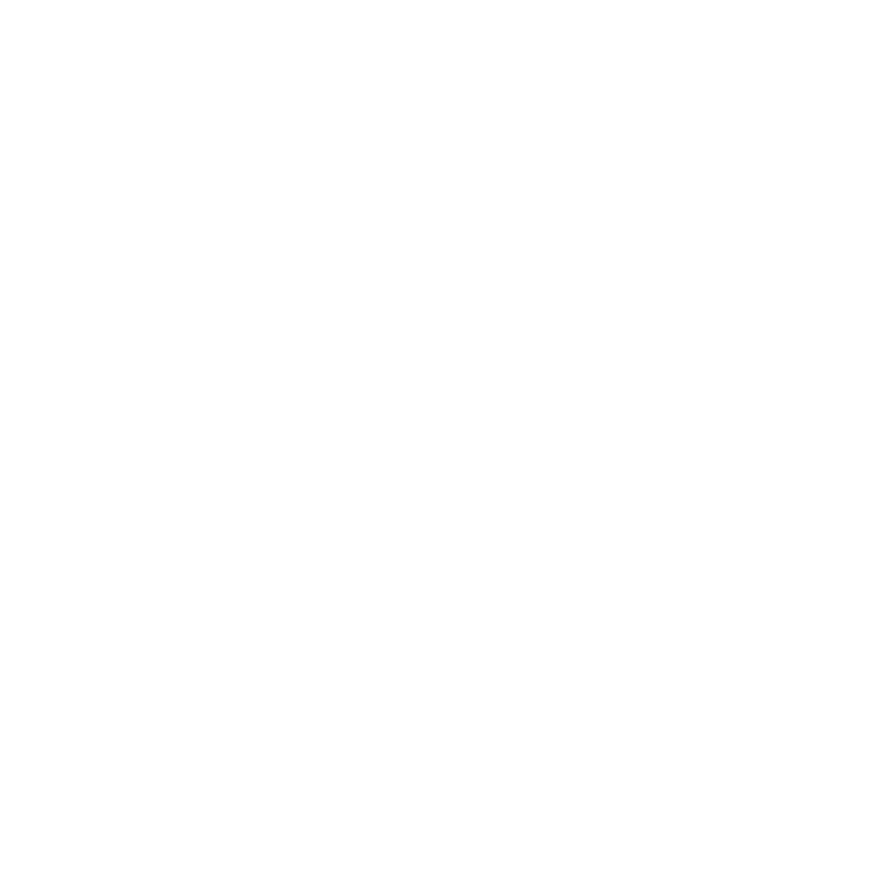 A modern building on a grassy hill with snow-capped mountains in the background.