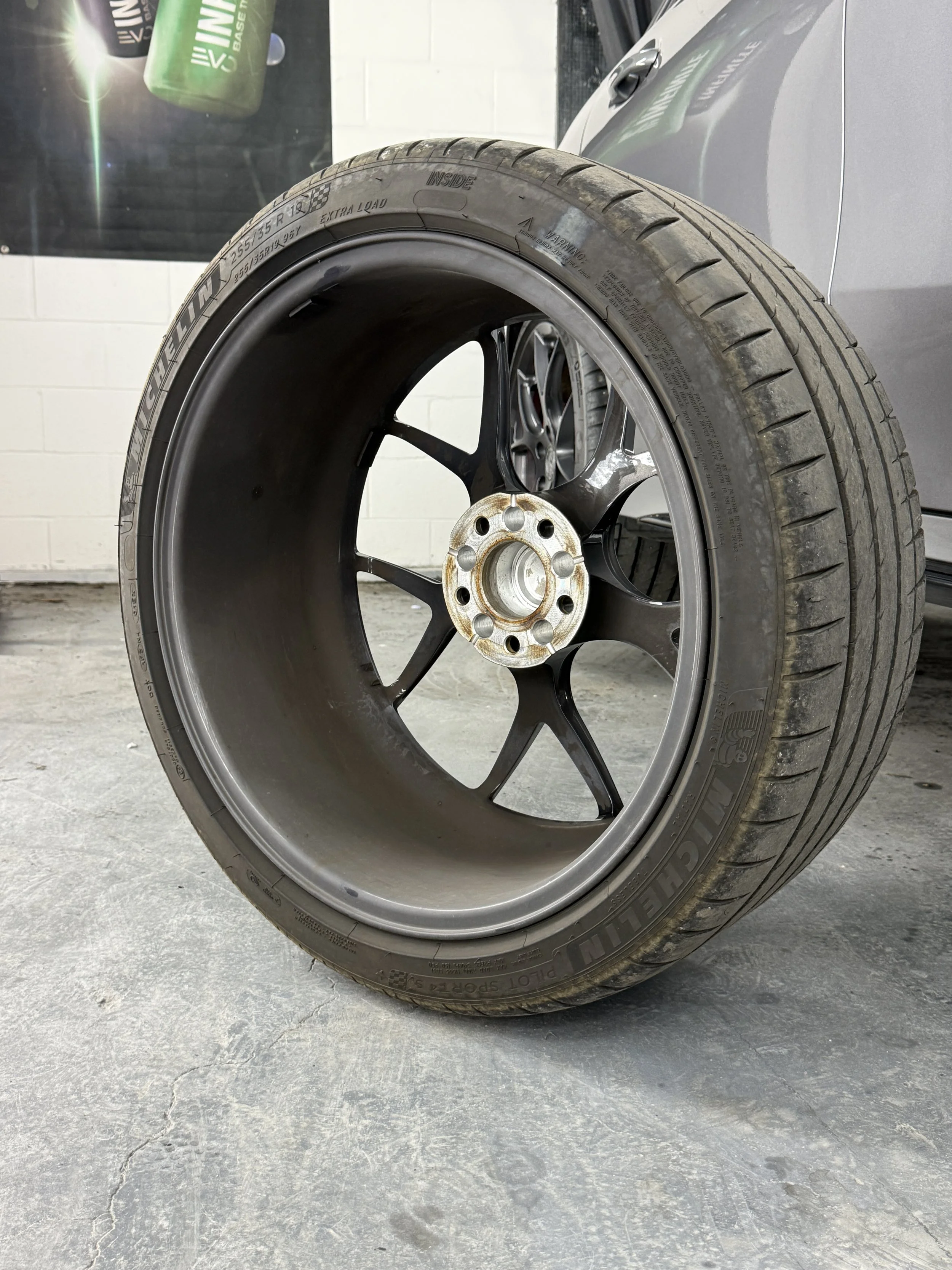 a wheel taken off the mercedes amg showing dirt on wheel barrel