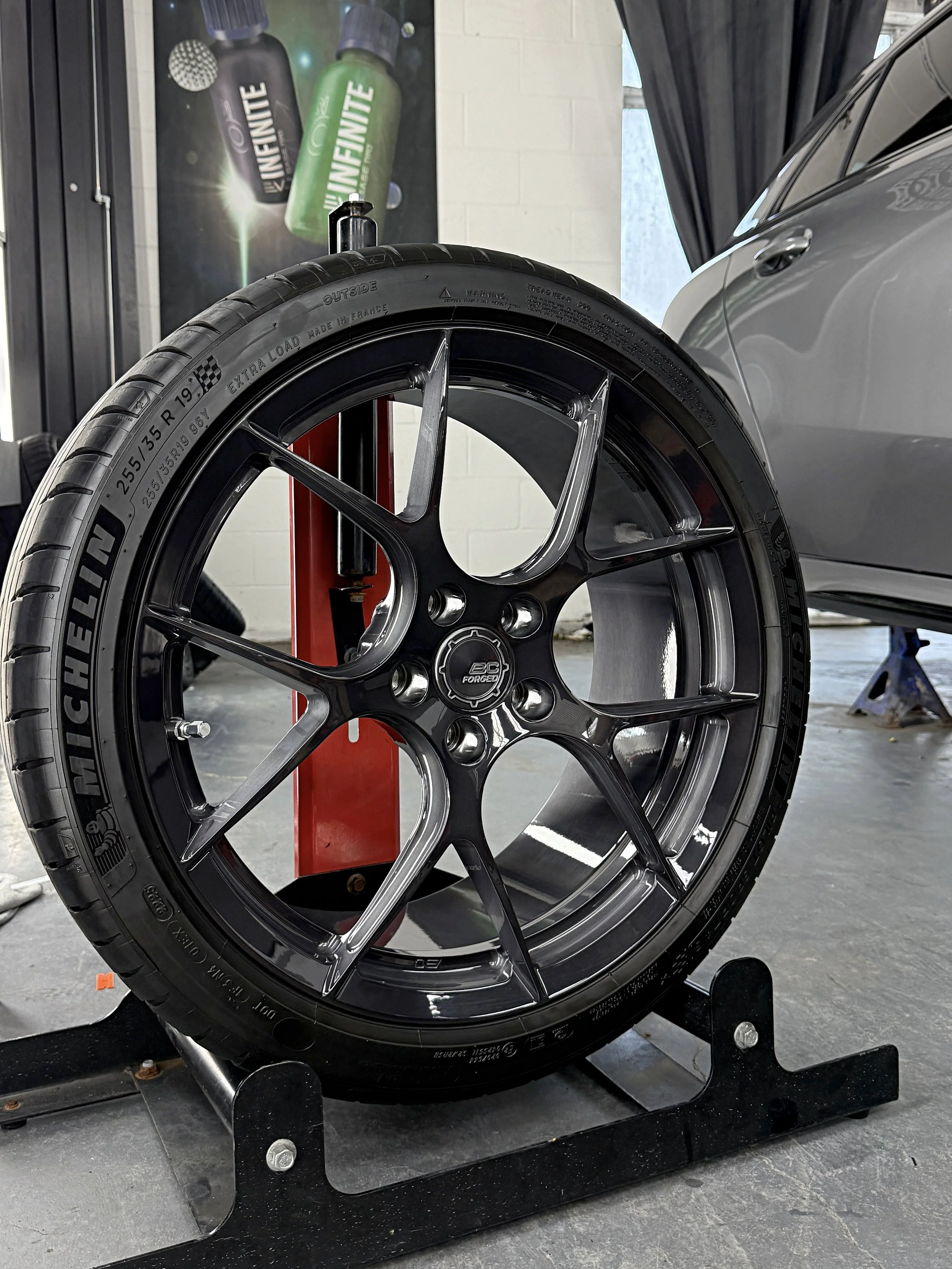 An AMG wheel on wheel stand perfecetly cleaned and ceramic coated for easier maintanence