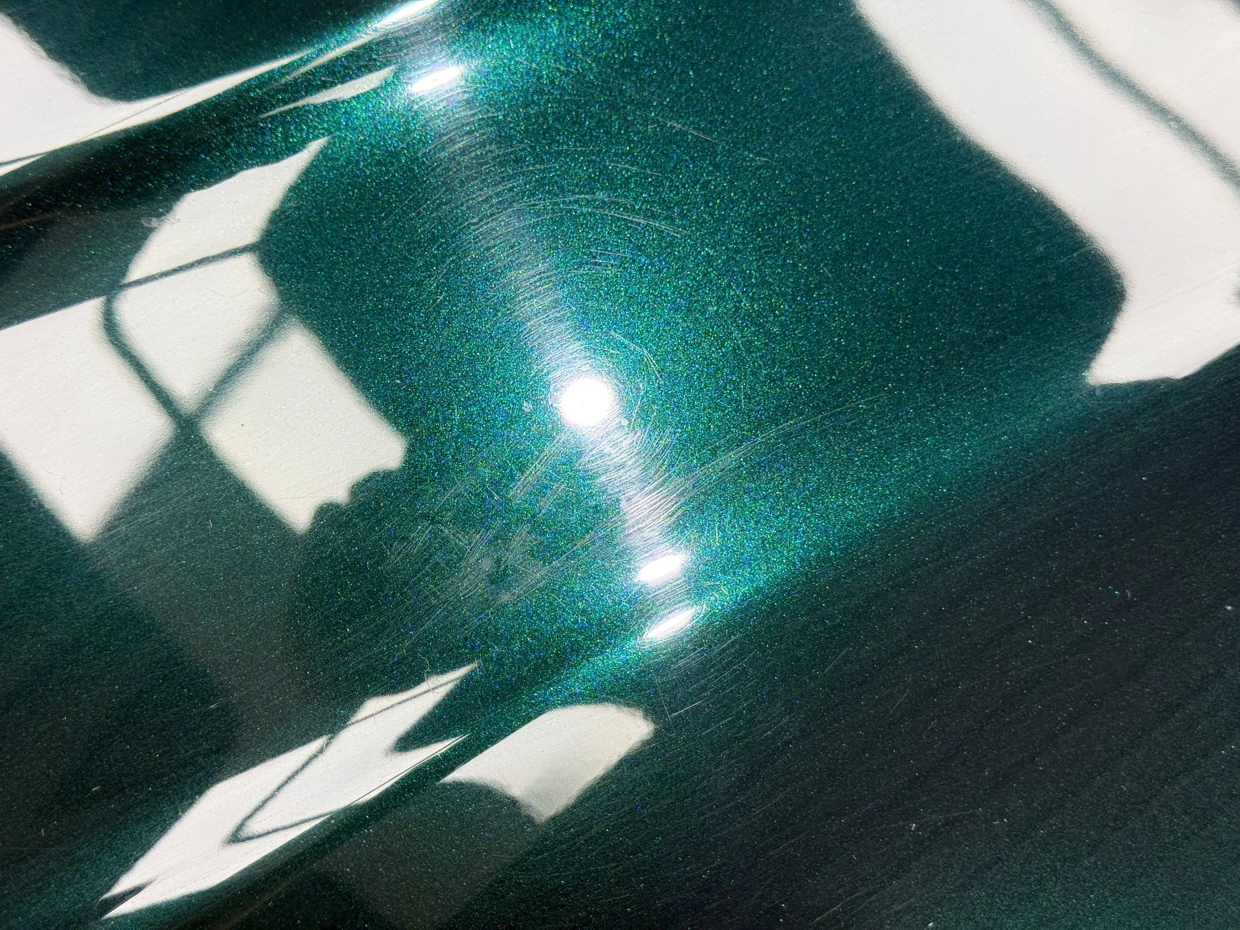 Heavy swirl marks and scratches on a Range Rover bonnet before paint enhancement
