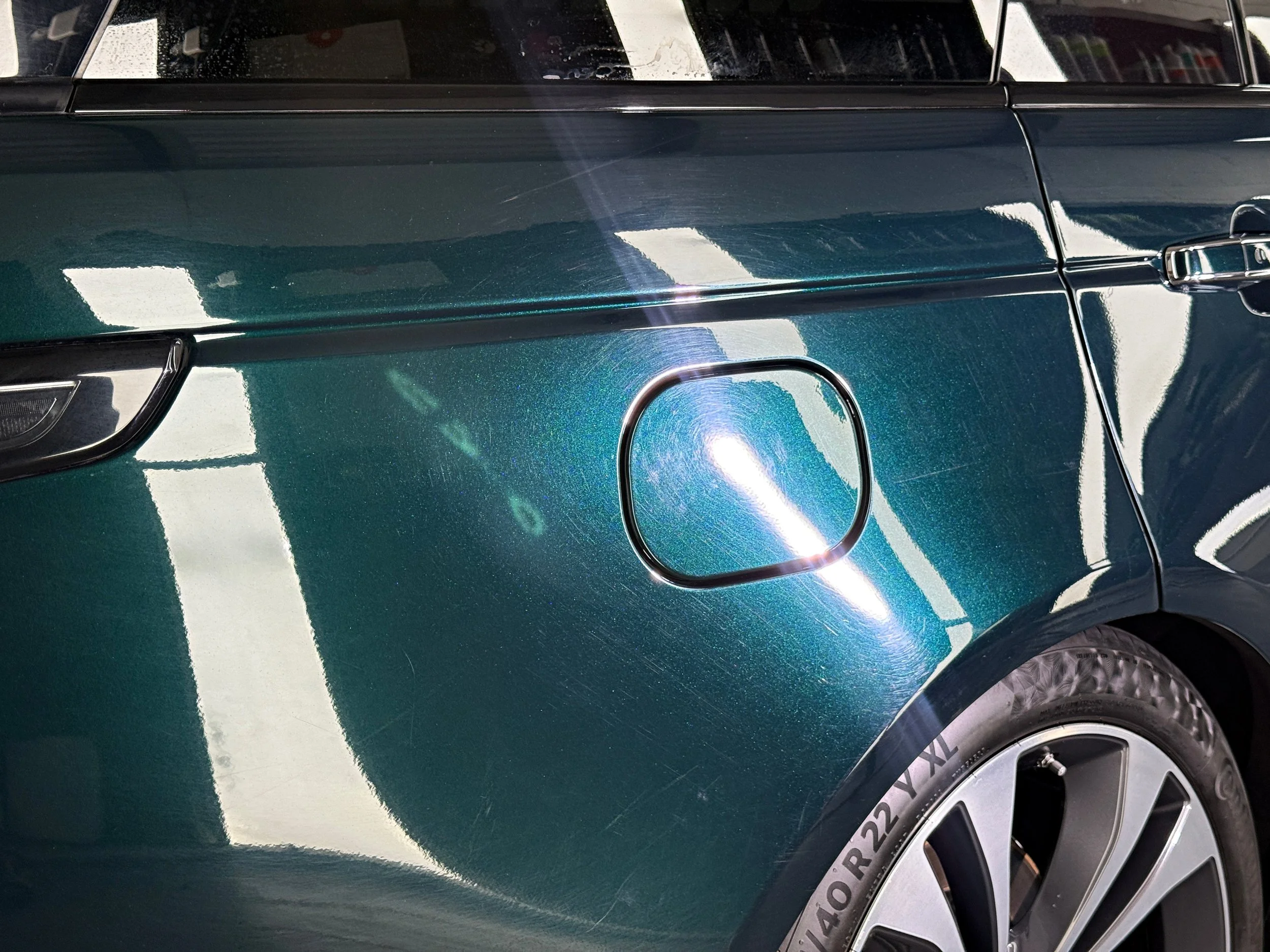 Swirl marks and scratches on the Range Rover rear quarter before machine polishing