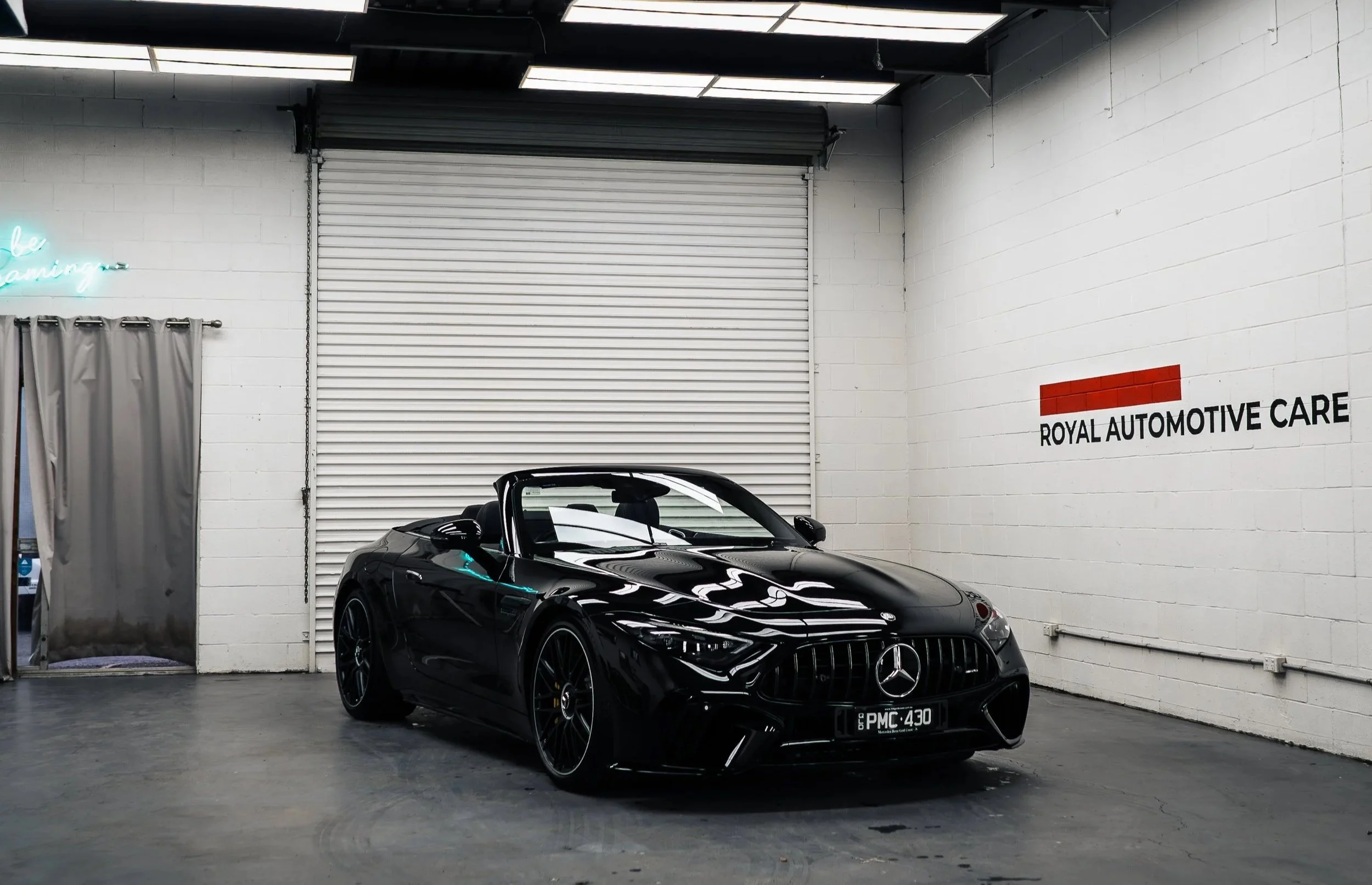 Black Mercedes-AMG SL63 with the roof down after paint refinement and GYEON Infinite Base ceramic coating at Royal Automotive Care’s Southport studio.