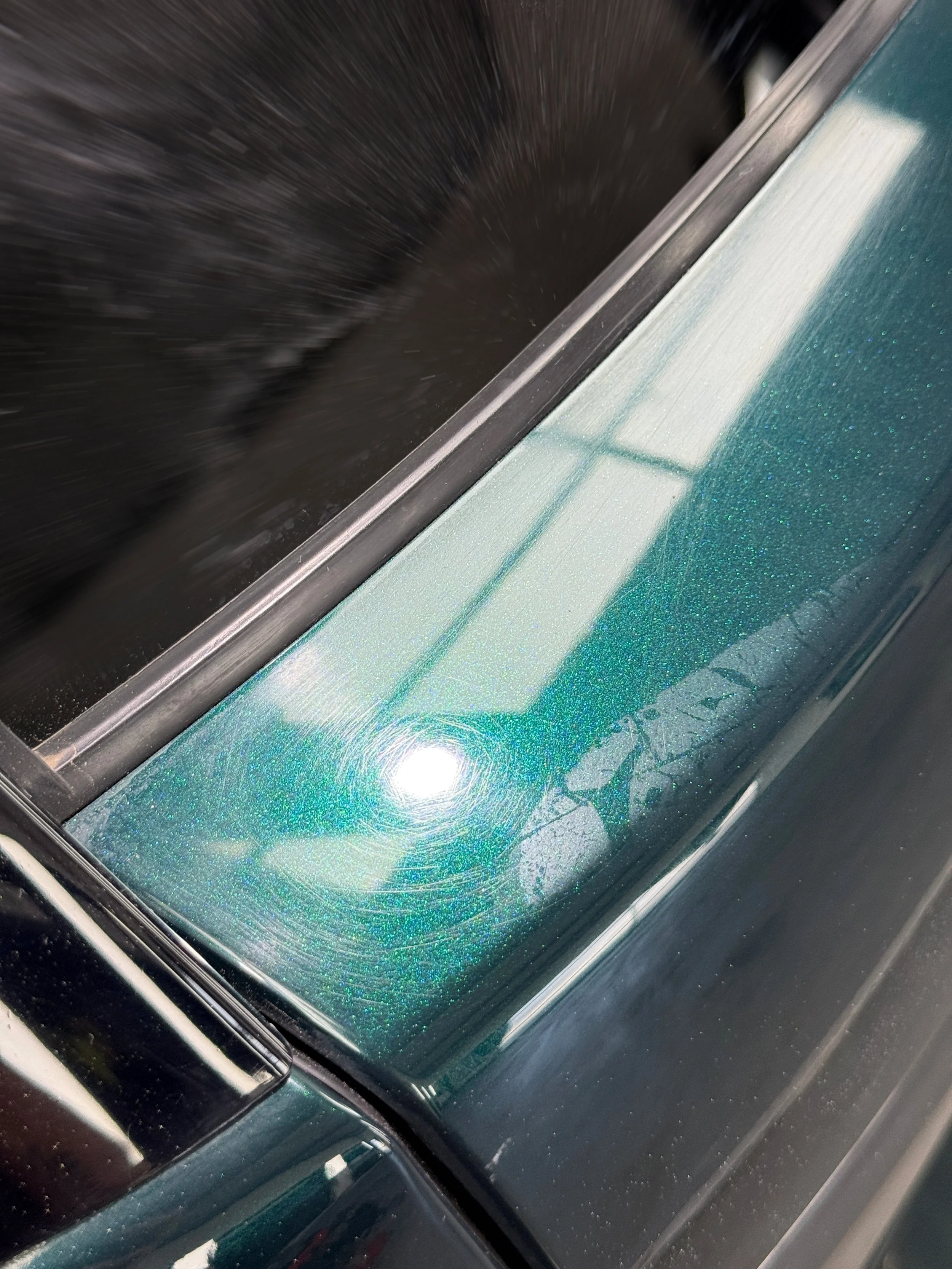 Swirl marks and paint defects on the Range Rover boot lid before machine polishing