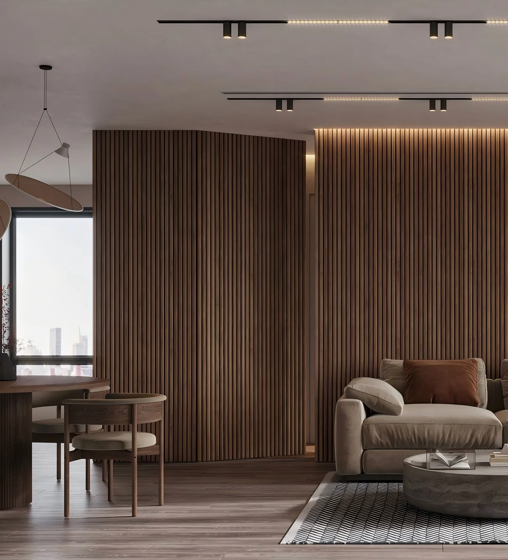 Modern living room with wood-paneled wall, beige sofa with brown pillow, round coffee table, black and white rug, and large window with city view.