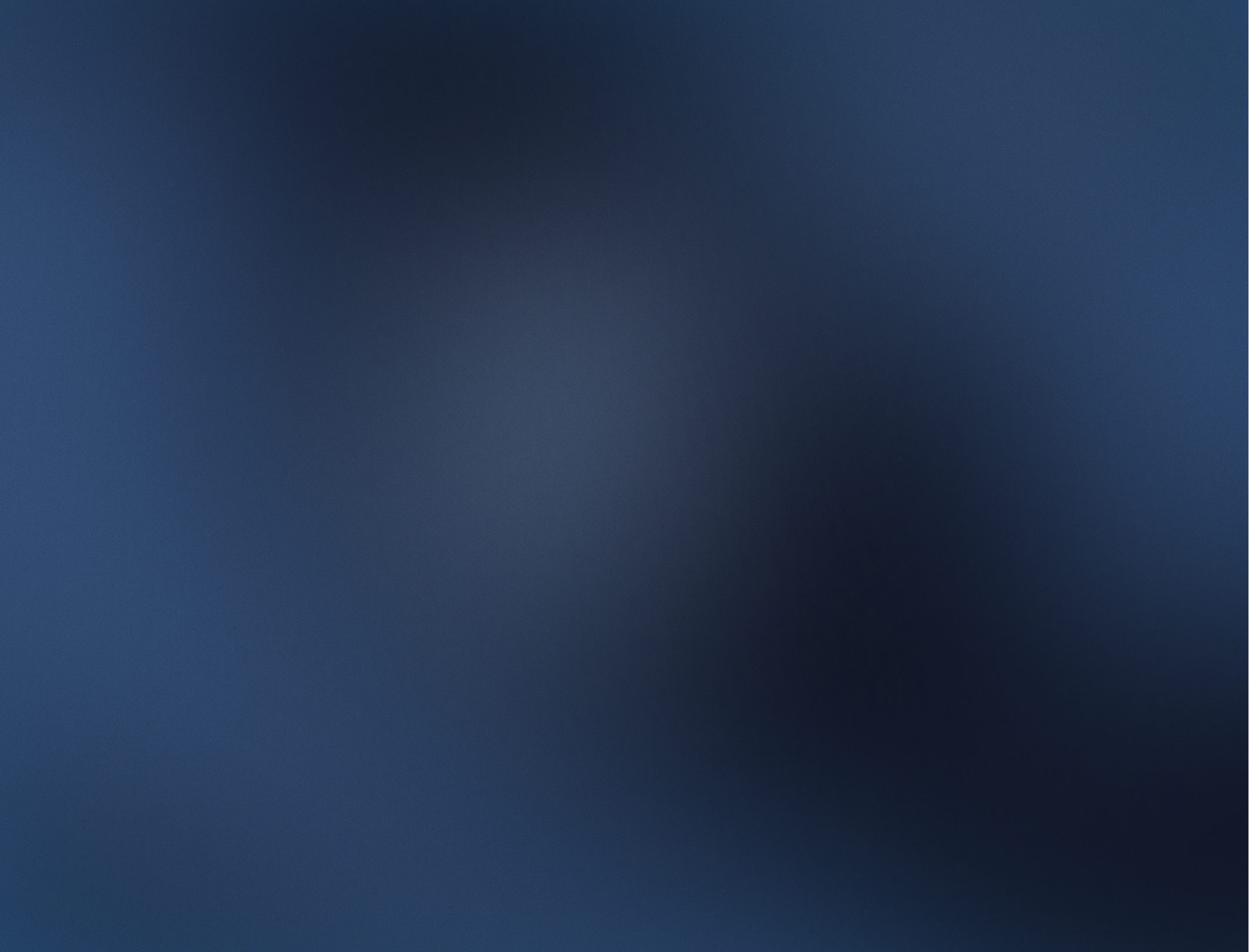 A dark blue gradient background with no distinct objects or features.