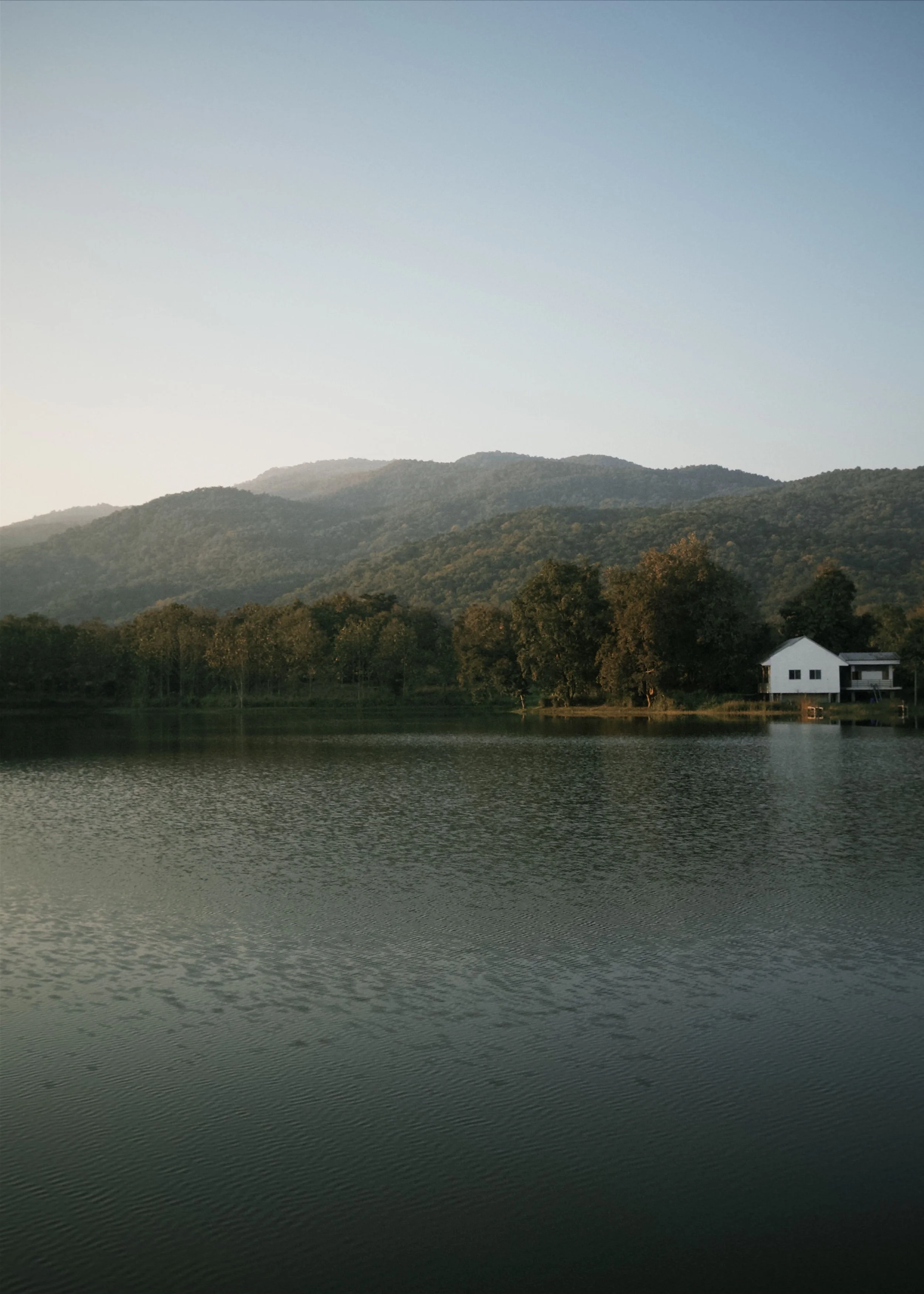 Peaceful mountain landscape and lake at dusk, representing relaxation and nervous system wellbeing