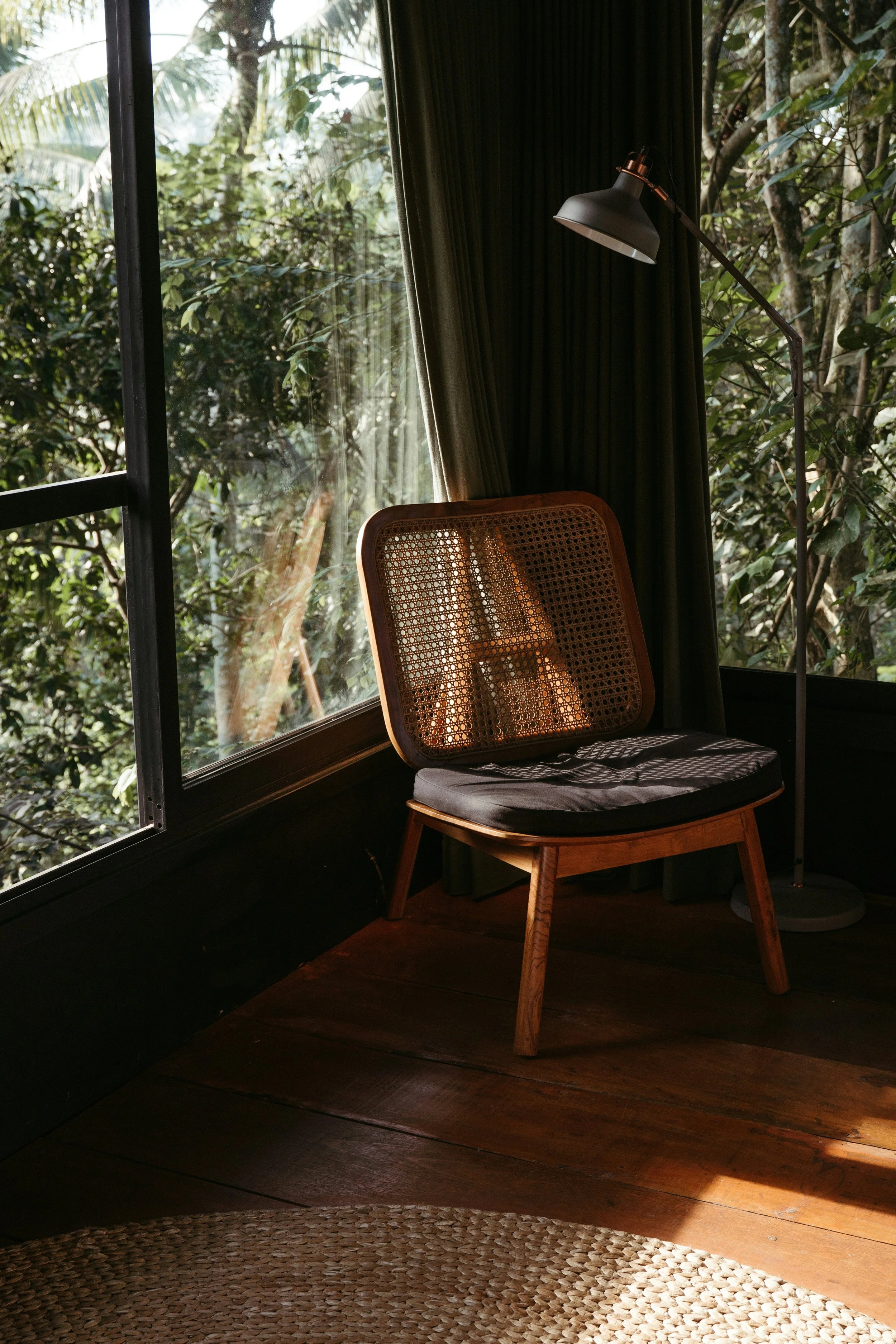 Quiet wellness space at Axia Wellness in Chiang Mai with wooden chair, natural light, and views of greenery