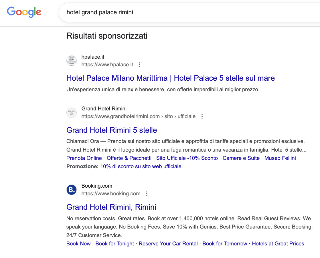 schermata di risultati sponsorizzati di Google per 'hotel grand palace rimini' con annunci di hotel a cinque stelle e recensioni.