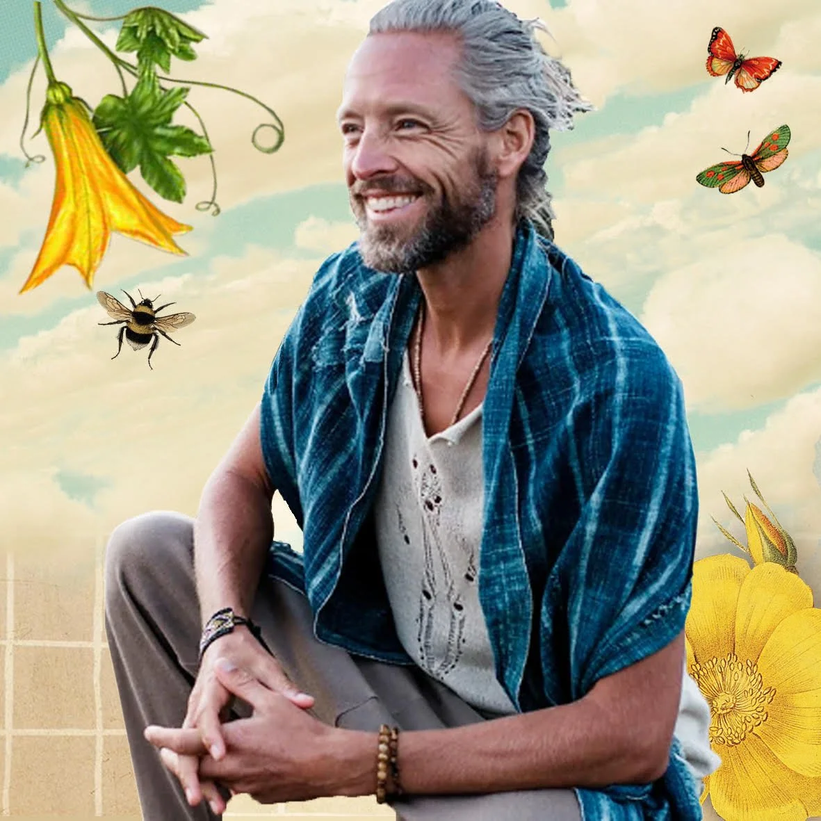 A mature man with gray hair and a beard, smiling and sitting outdoors. He wears a blue plaid shirt over a distressed white t-shirt. The background features a partly cloudy sky, flowers, butterflies, and a bee, creating a natural and peaceful scene.