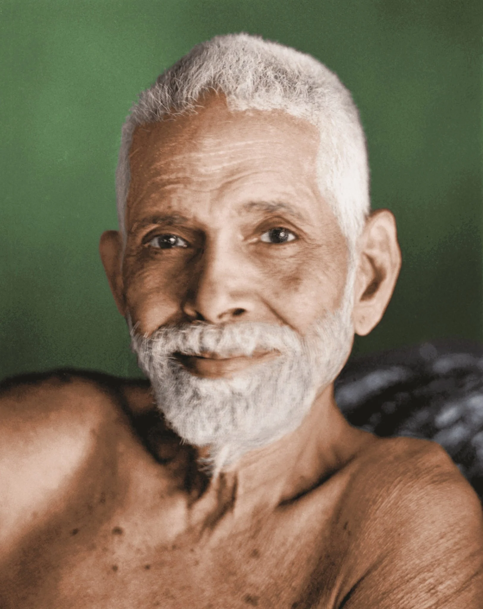 A close-up of an elderly man's face, showing his eyes, nose, part of his forehead, and a white beard and mustache, against a green background.