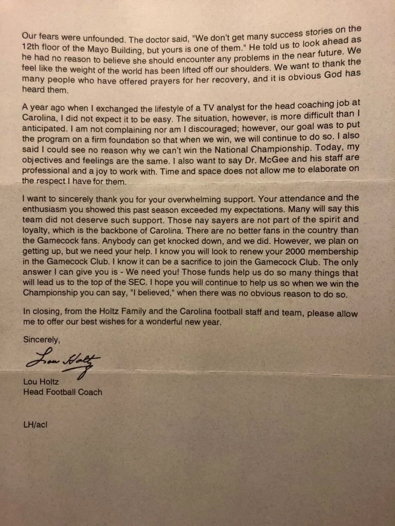 A typed letter from Lou Holtz, head football coach of the Carolina team, expressing thanks and encouragement, signed with a handwritten signature.