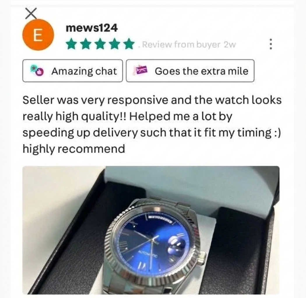 A blue face automatic wristwatch inside a black box.