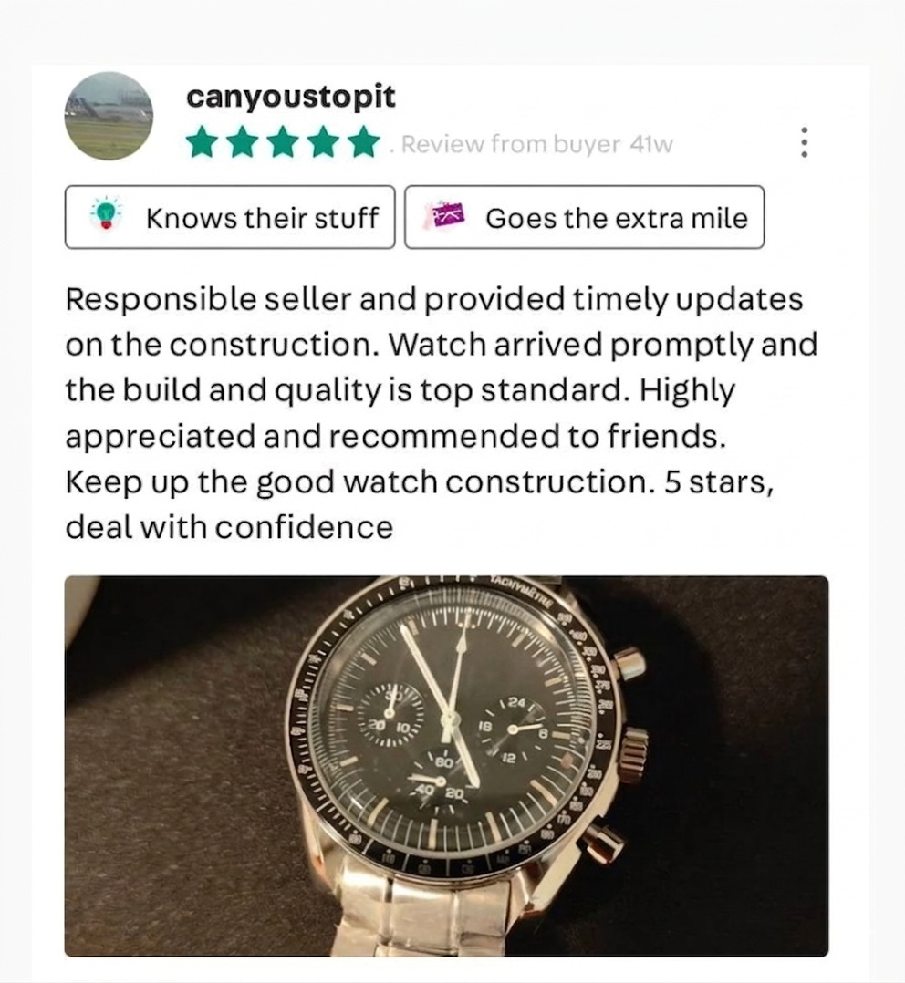 Close-up of a black chronograph wristwatch with multiple dials and a silver band, positioned on a dark surface.