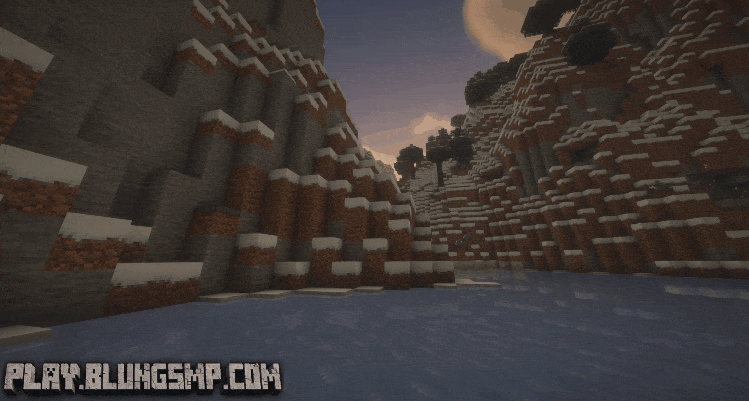 A screenshot from a Minecraft game showing a snowy canyon with water at the bottom, tall cliffs on either side, and a sunset or sunrise in the sky.
