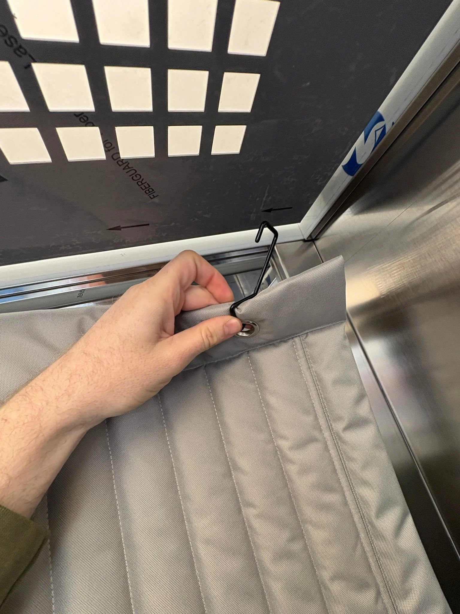 Lift drape being hung in lift