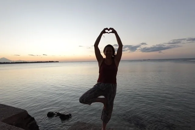 balancing with heart infront of water in bali.JPG