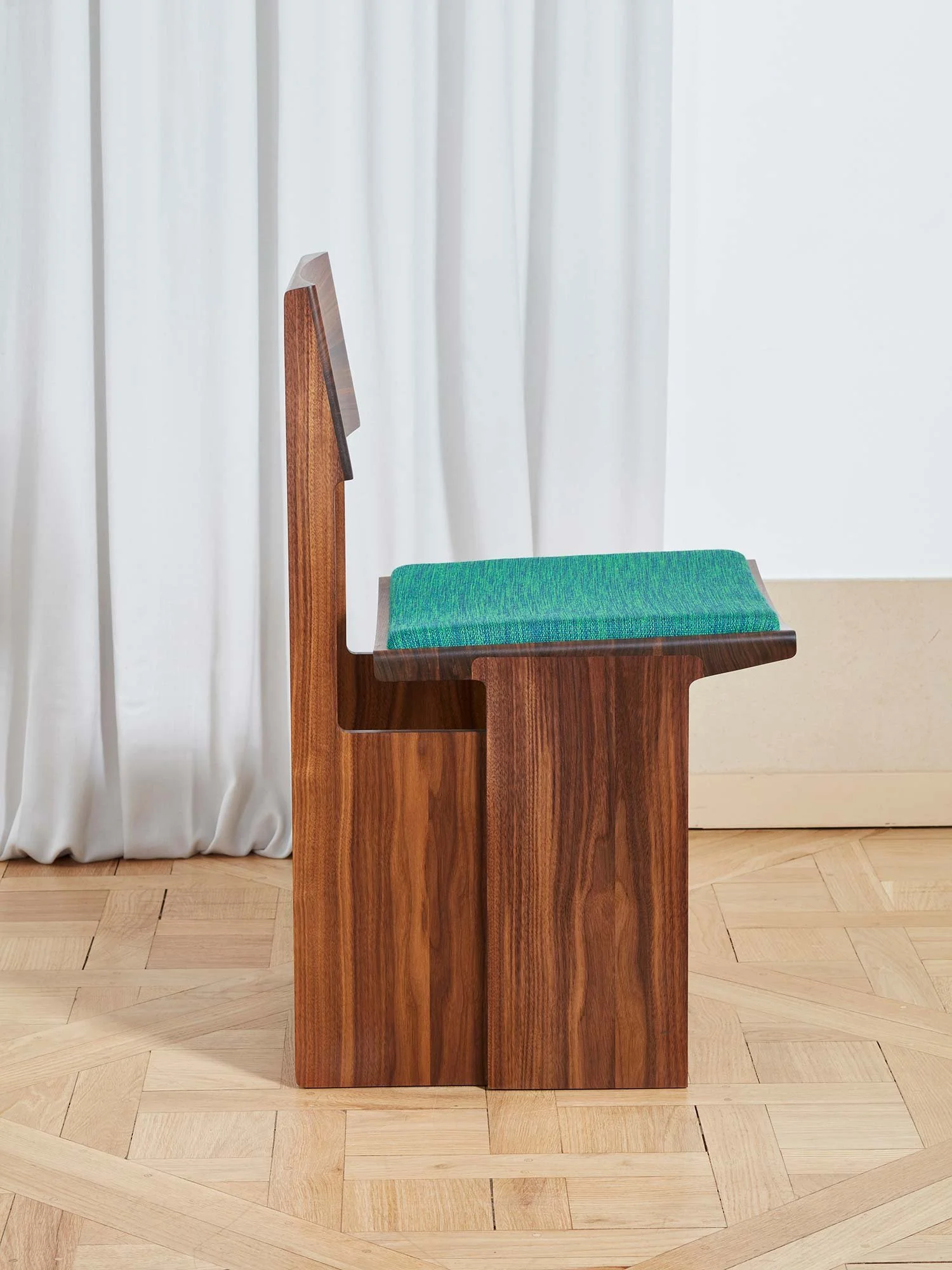 Drift chair in natural walnut wood side view