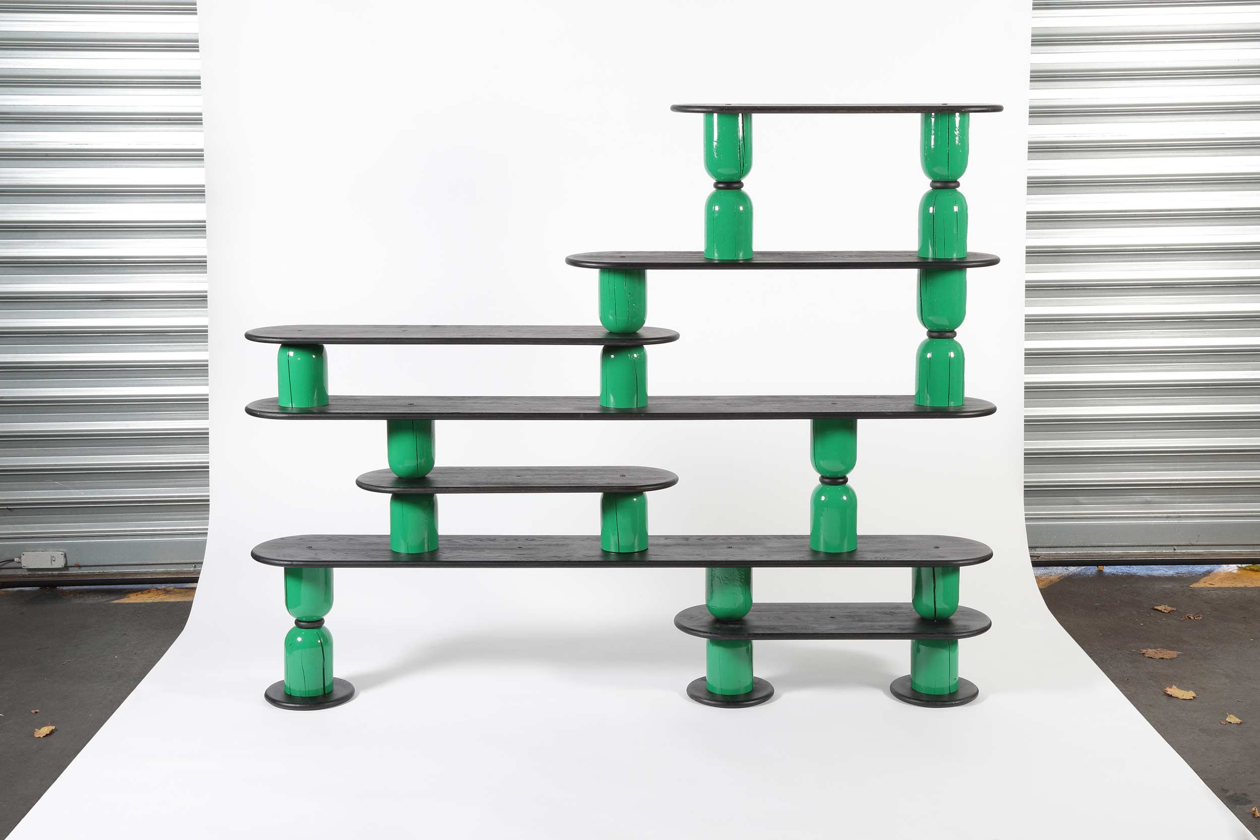 Shelving system to be composed with glossy colour stands and black boards