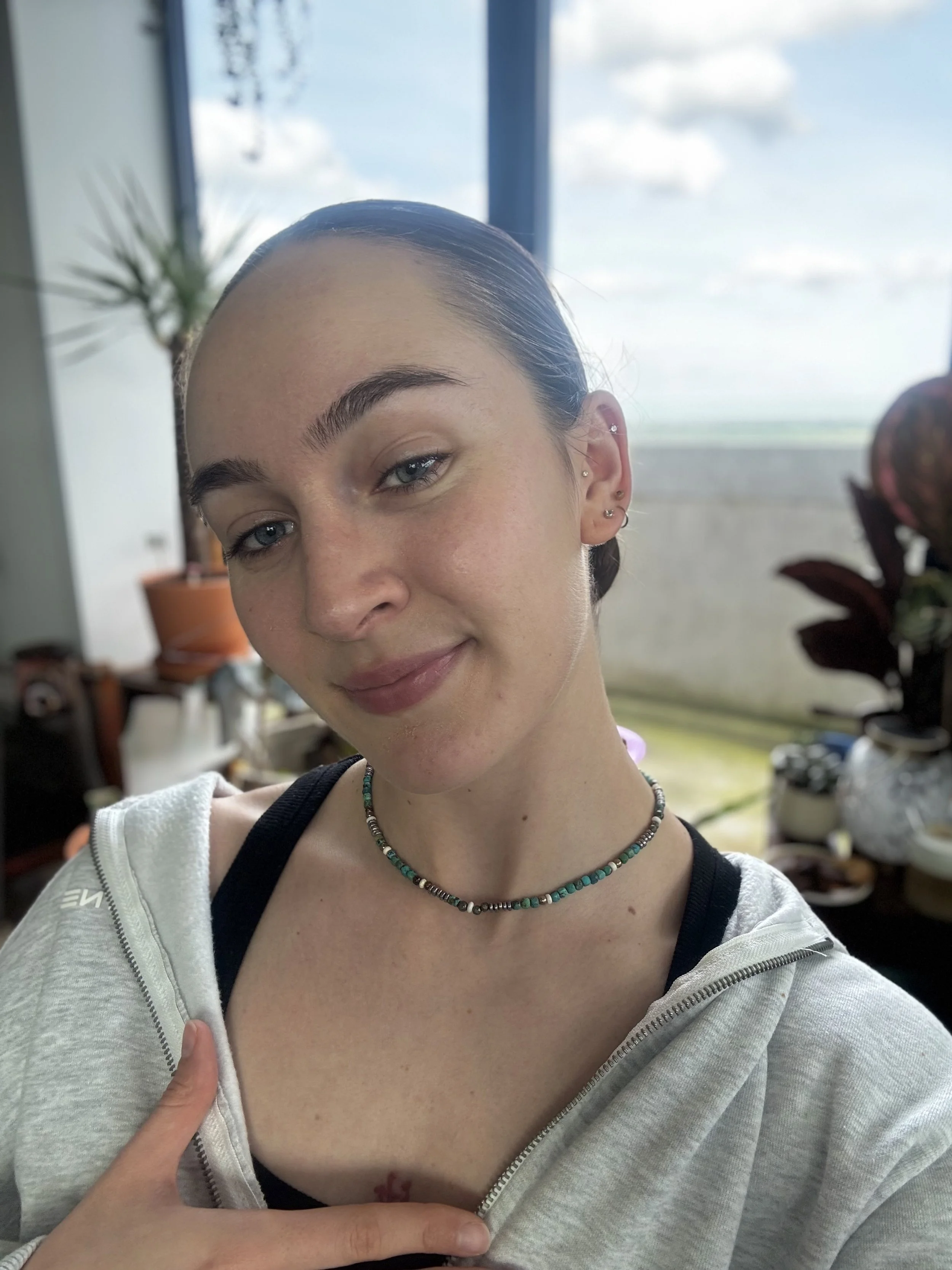 Review of a woman wearing a beaded necklace