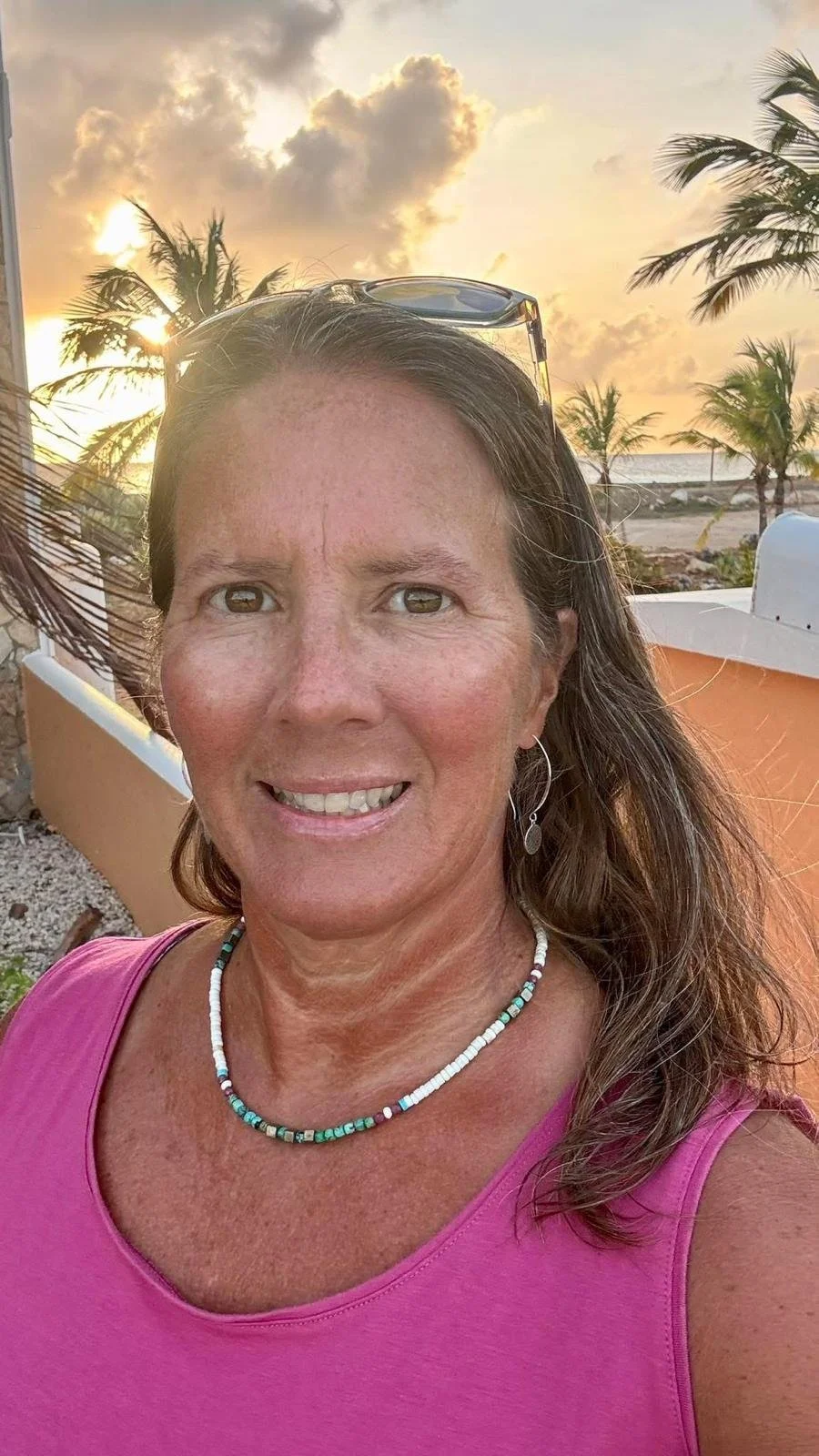 Review of a woman wearing a beaded necklace.