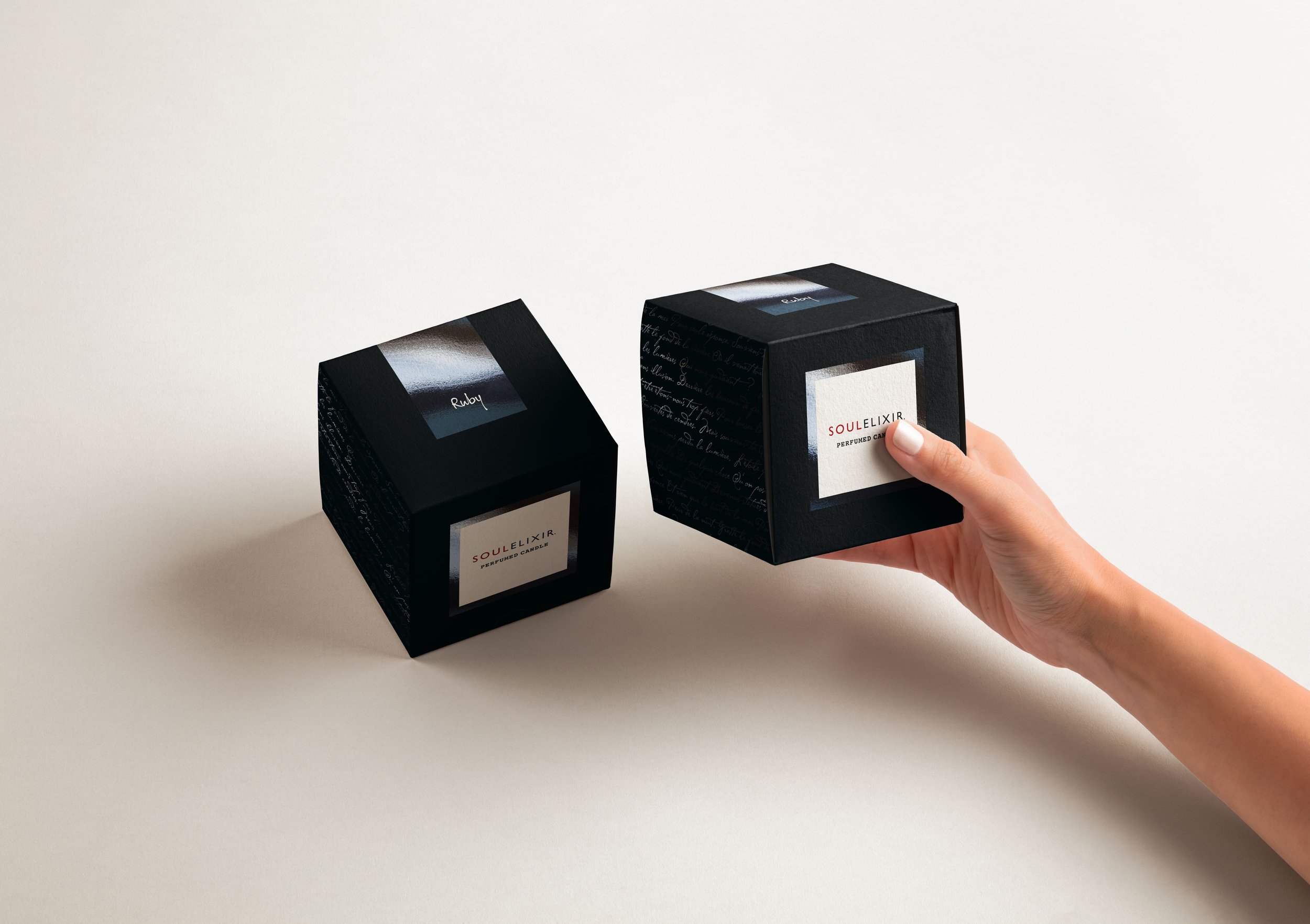 Hand-Holding-Cardboard-Brand-Cube-Boxes-Free-psd-Mockup.jpg