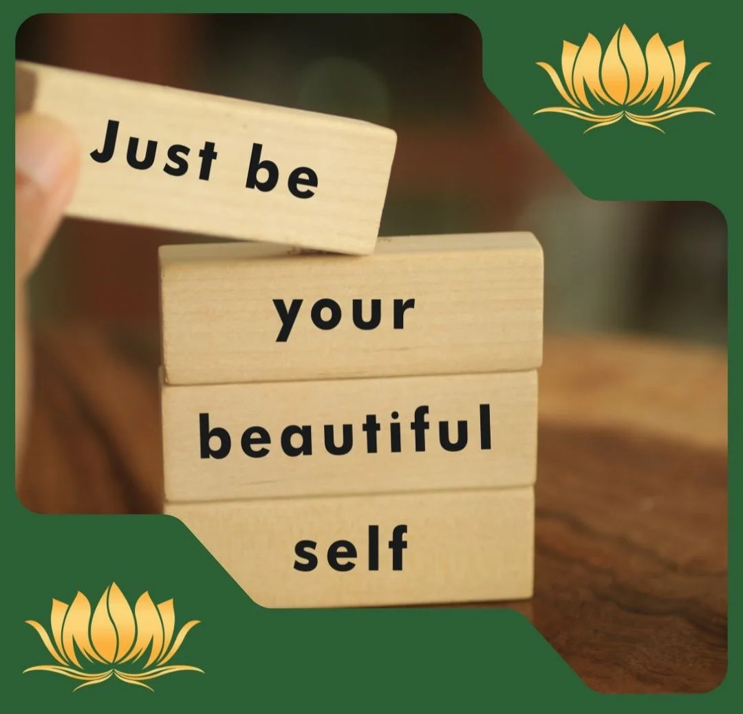 Wooden blocks spelling out 'Just be your beautiful self' with a green and gold decorative border featuring a lotus flower at the top right and bottom left corner.