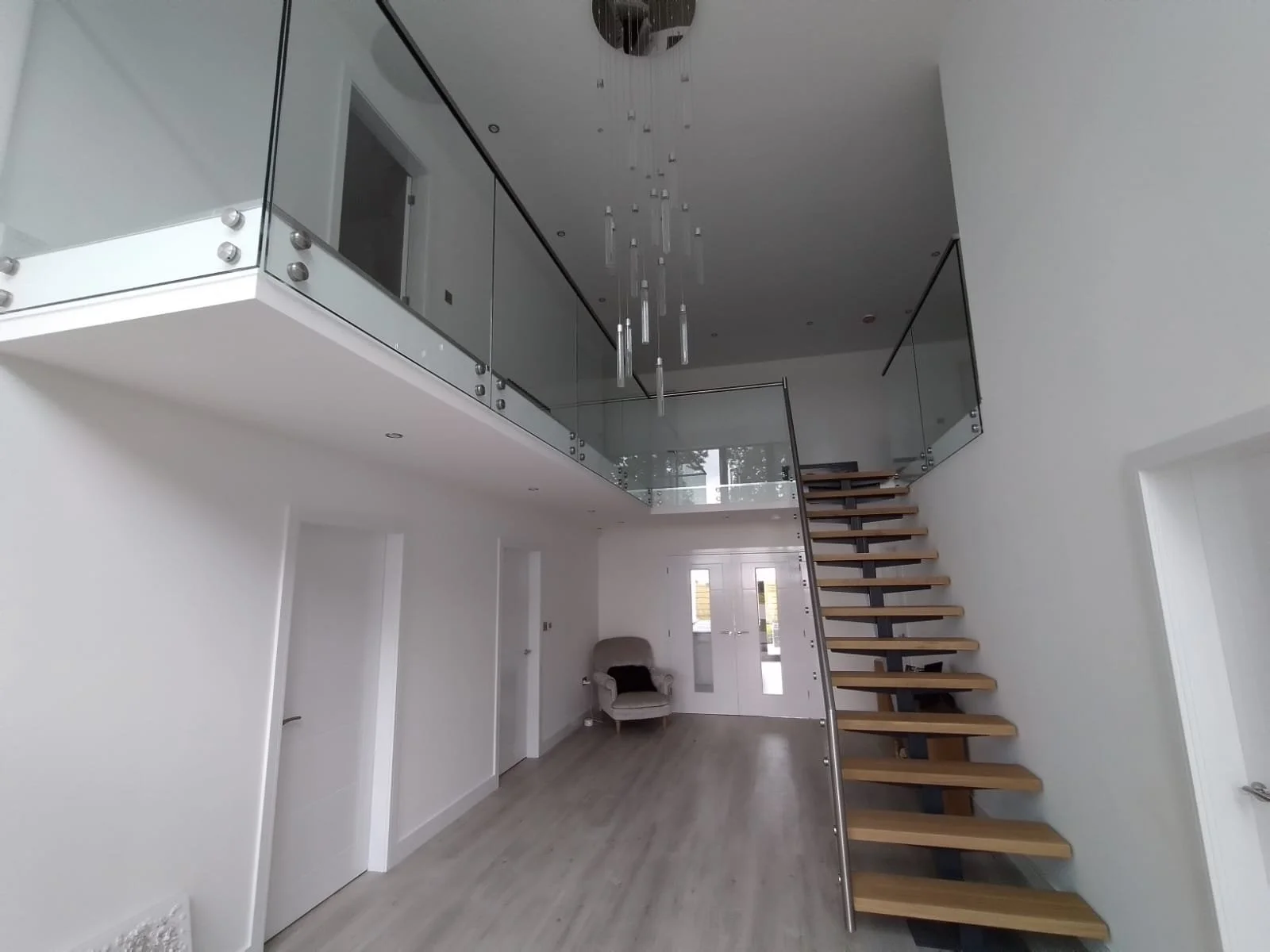 Stainless steel balcony balustrade with glass panels by Gemfabs