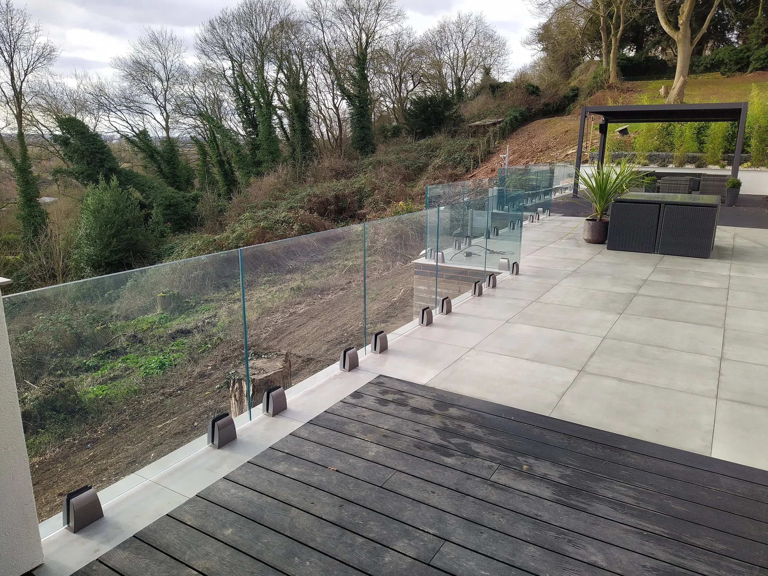 Stainless steel outdoor balcony balustrade with glass panels by Gemfabs