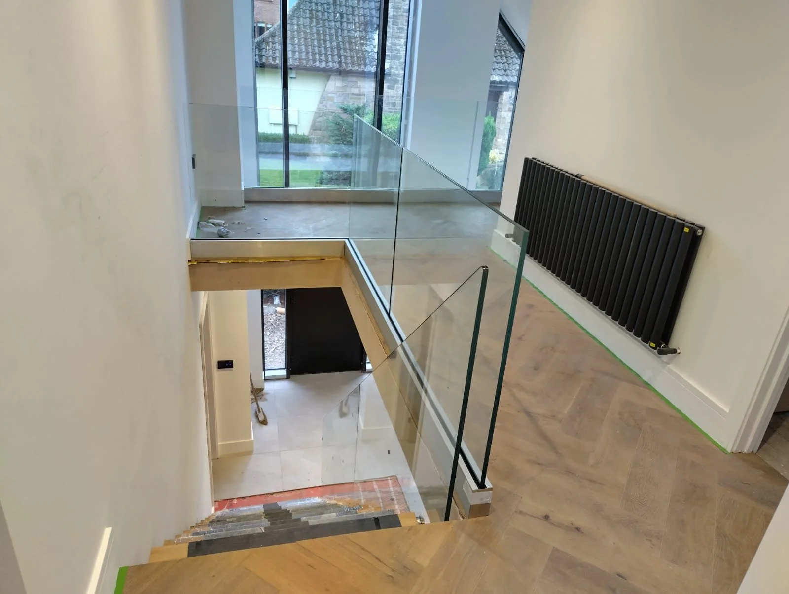 Contemporary stainless steel internal staircase railings and safety glass for domestic and commercial properties by Gemfabs