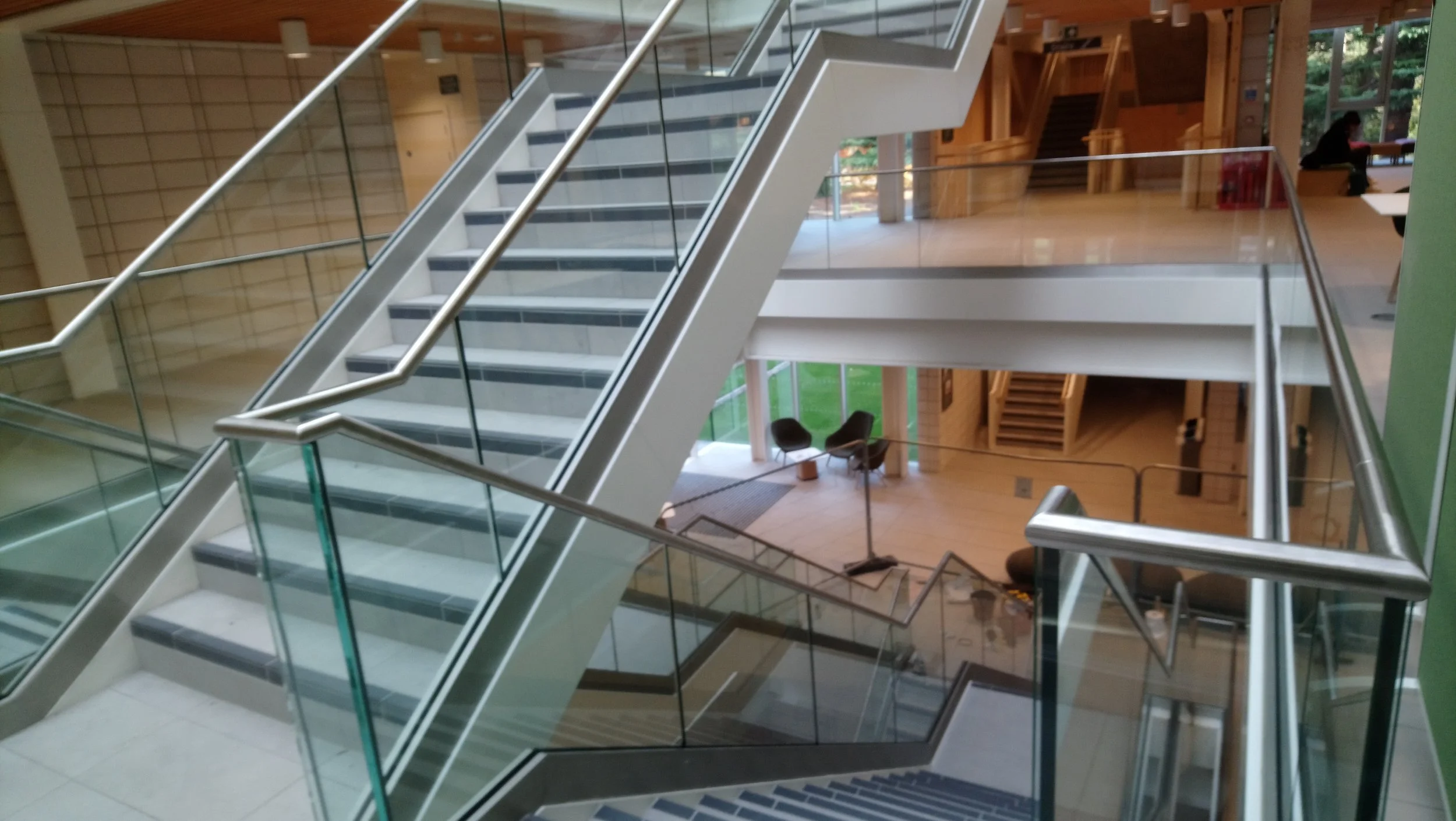 Contemporary commercial steel staircase with bespoke balustrade by Gemfabs