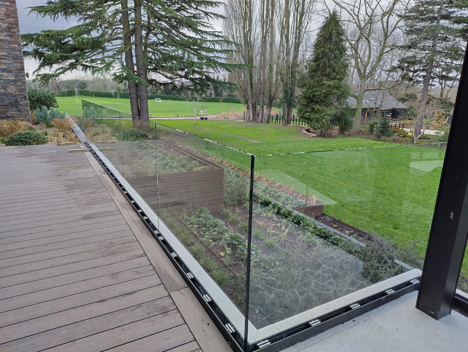 Stainless steel balcony balustrade with glass panels by Gemfabs Nottingham