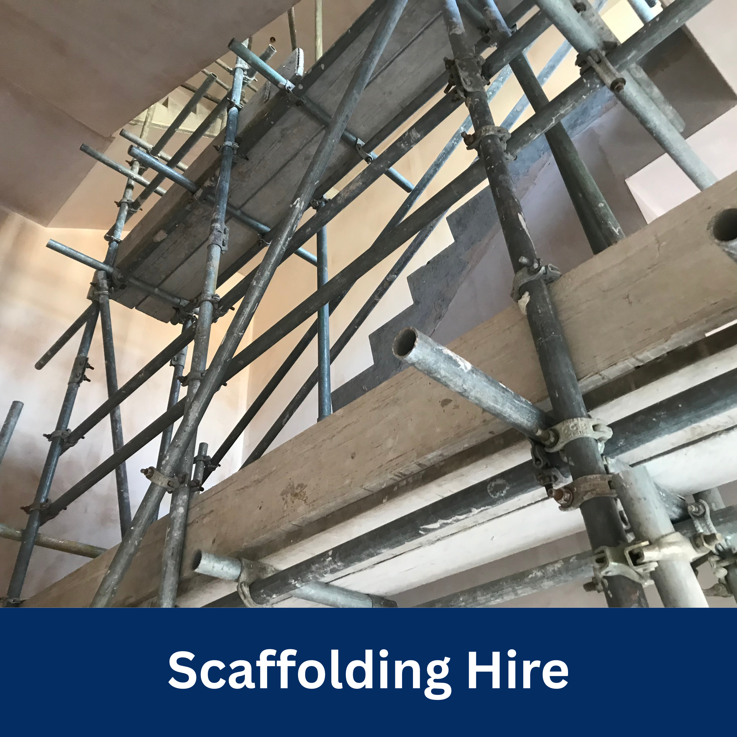 Metal scaffolding and wooden planks set up inside a building, labeled as 'Scaffolding Hire'