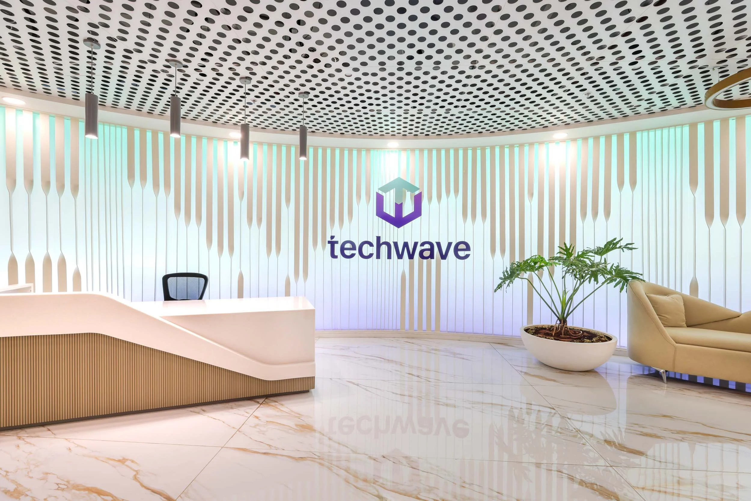 Commercial interior photography showcasing a spacious corporate lobby, highlighting custom reception desk design, polished flooring, and unique architectural ceiling elements