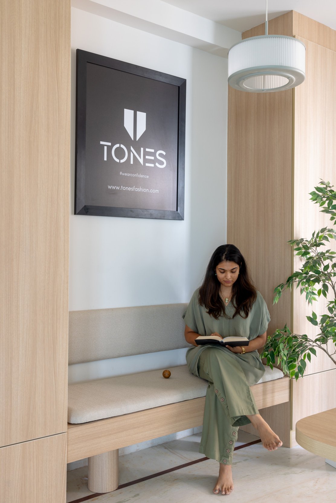 Commercial interior photography showcasing a custom wood-paneled office waiting area, highlighting modern corporate branding and an inviting reception design