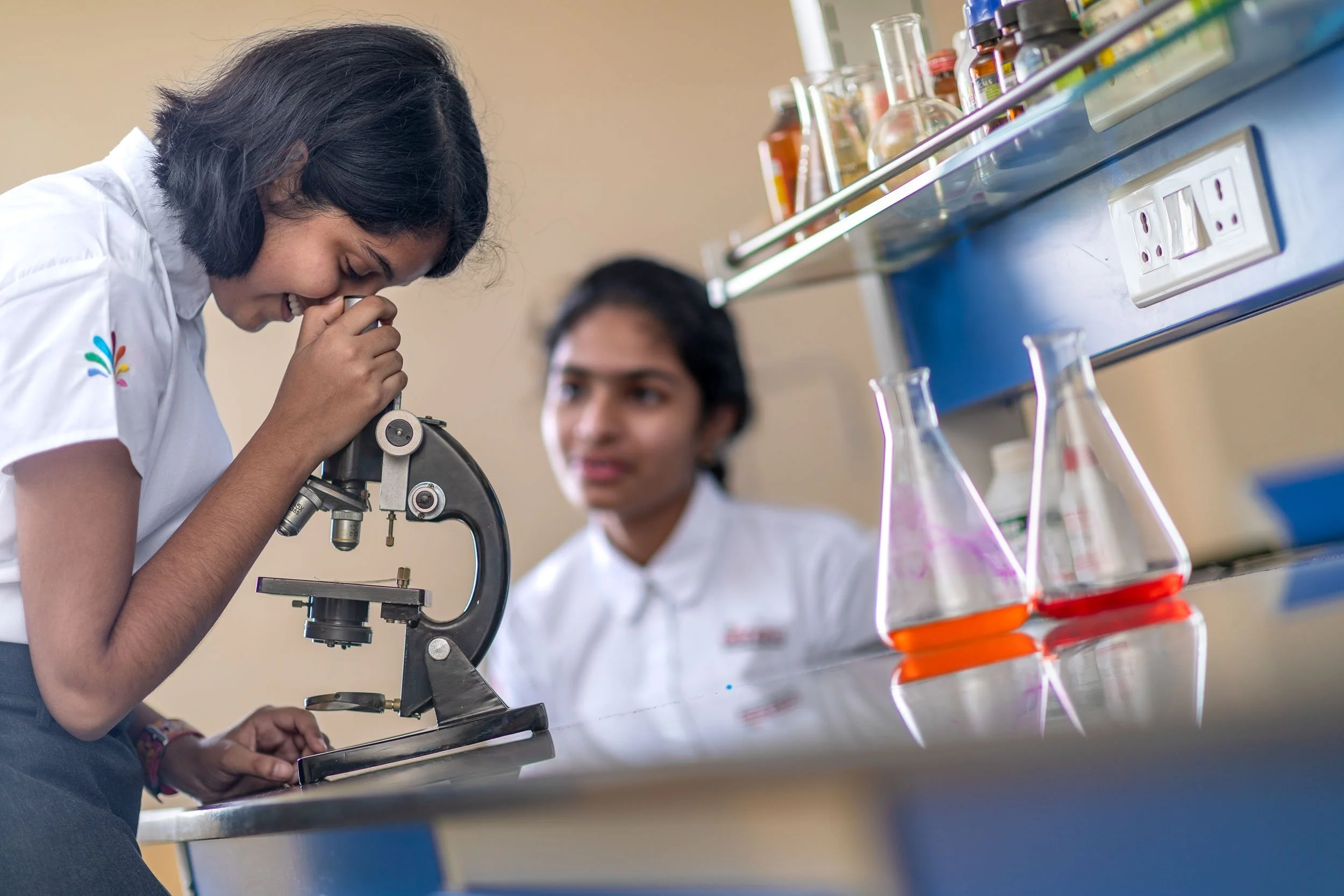 

Interior school photography of students using a microscope and conducting experiments in a modern science laboratory

























