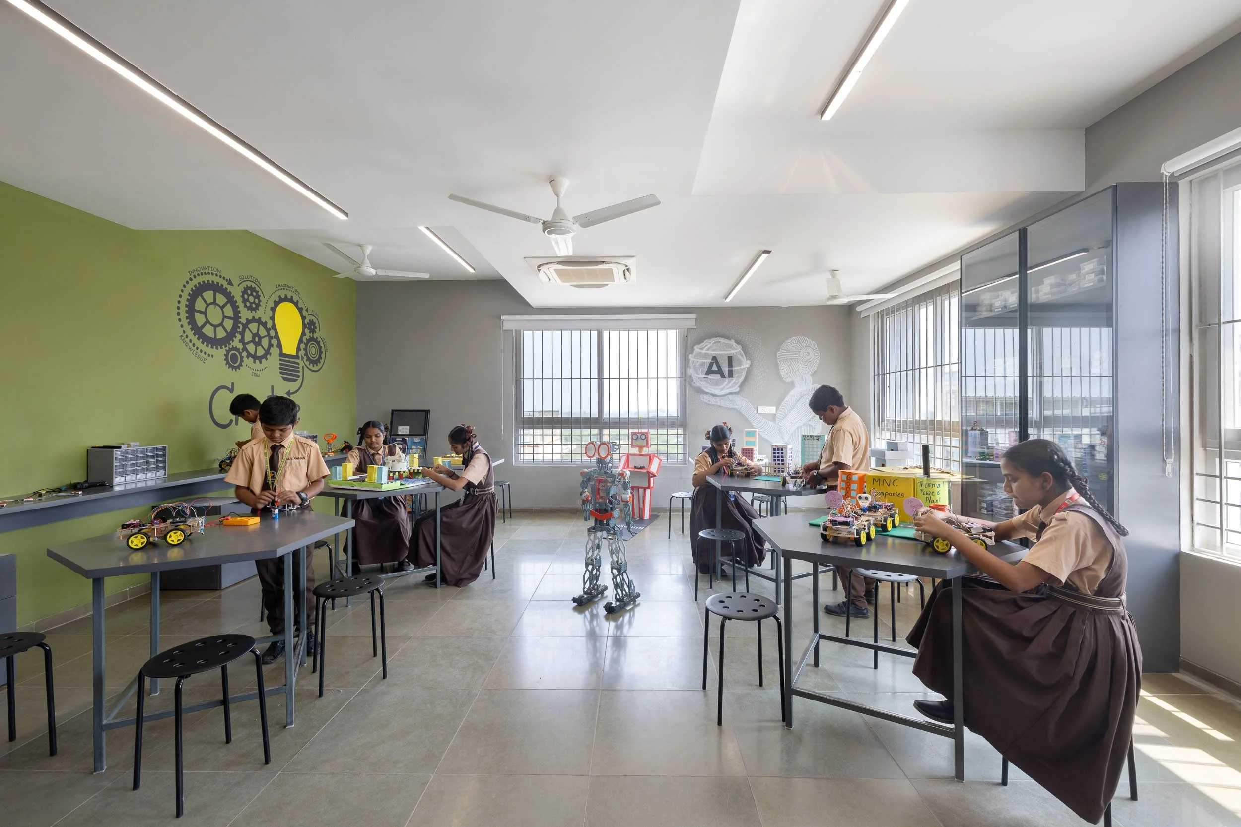 Interior school photography highlighting a bright, spacious multi-purpose room with students engaged in collaborative activities