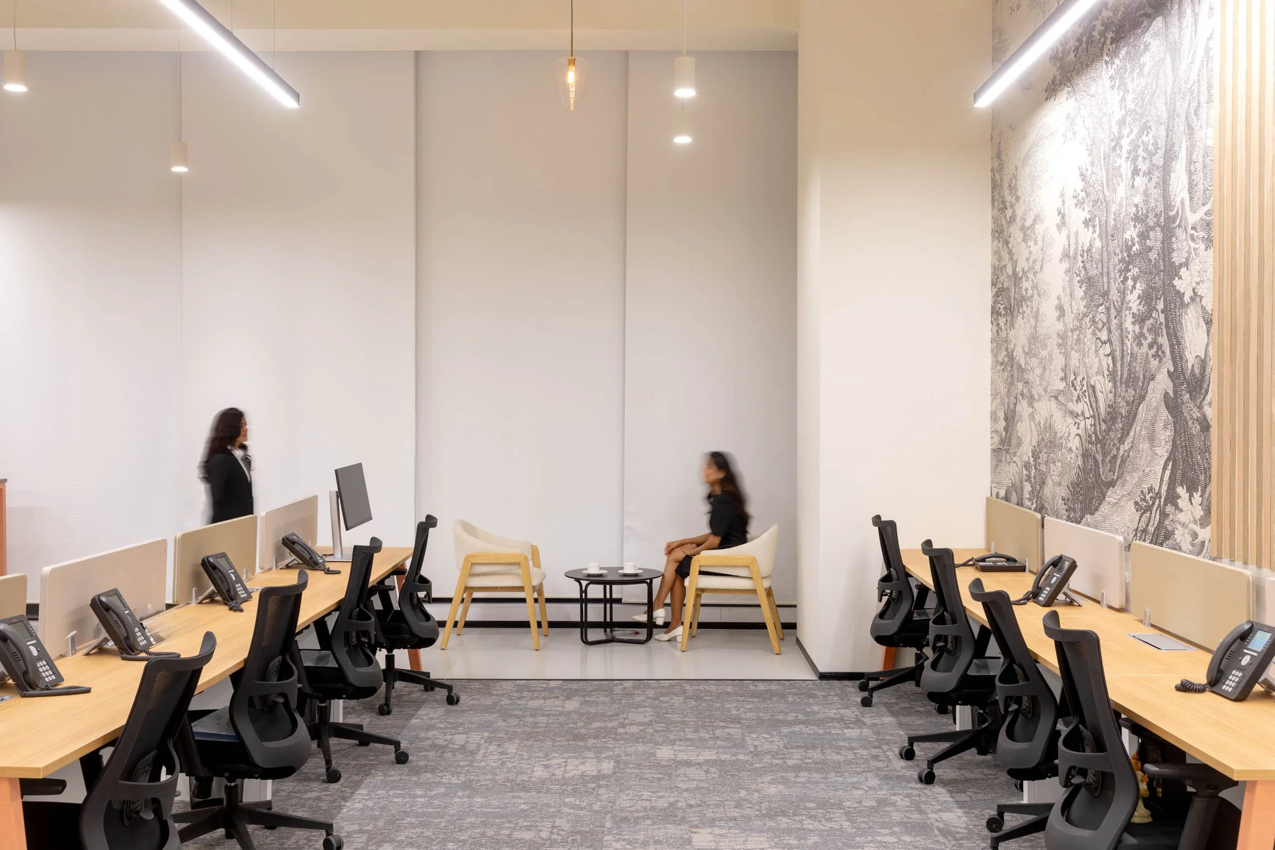 Commercial interior photography showcasing a spacious open-plan corporate workspace, highlighting ergonomic seating, modern desk arrangements, and a well-lit environment