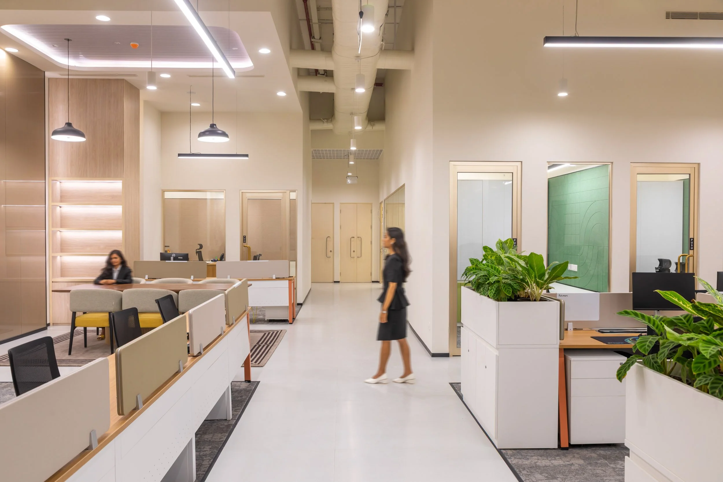 Commercial interior photography showcasing a brightly lit, modern corporate workspace and reception area with sleek architectural lines